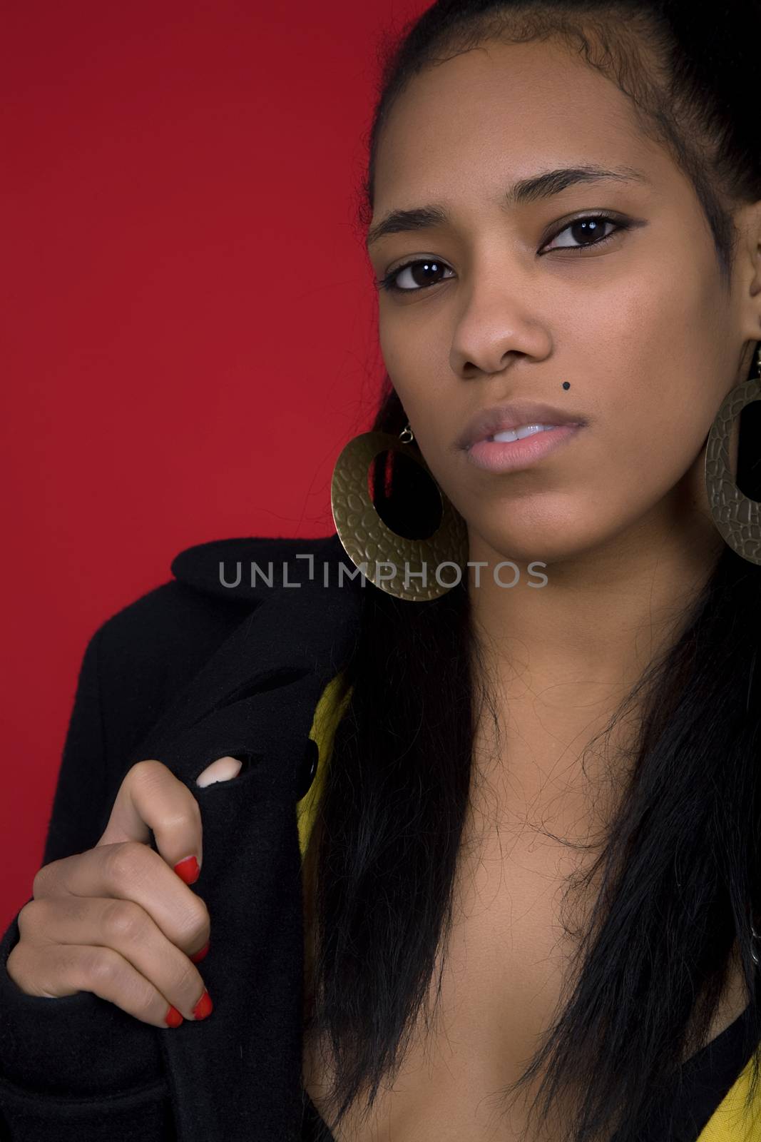 young beautiful woman closeup portrait, on a red background