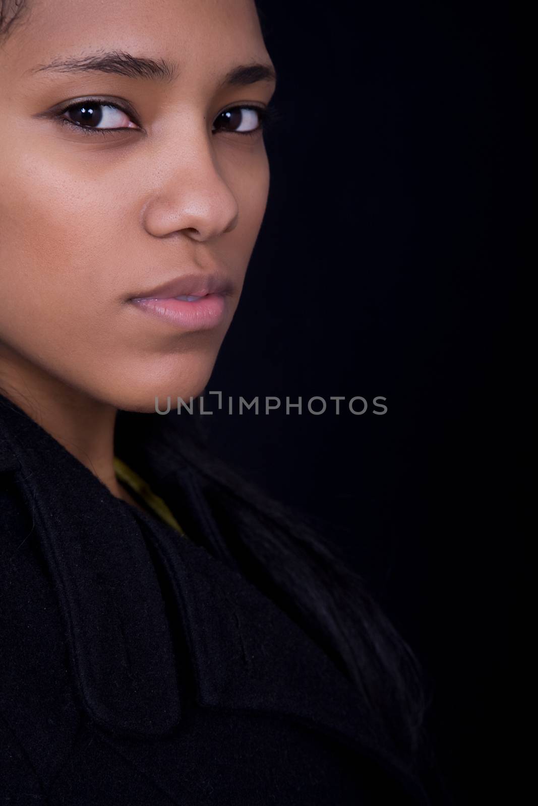 young beautiful woman close up portrait, on black background