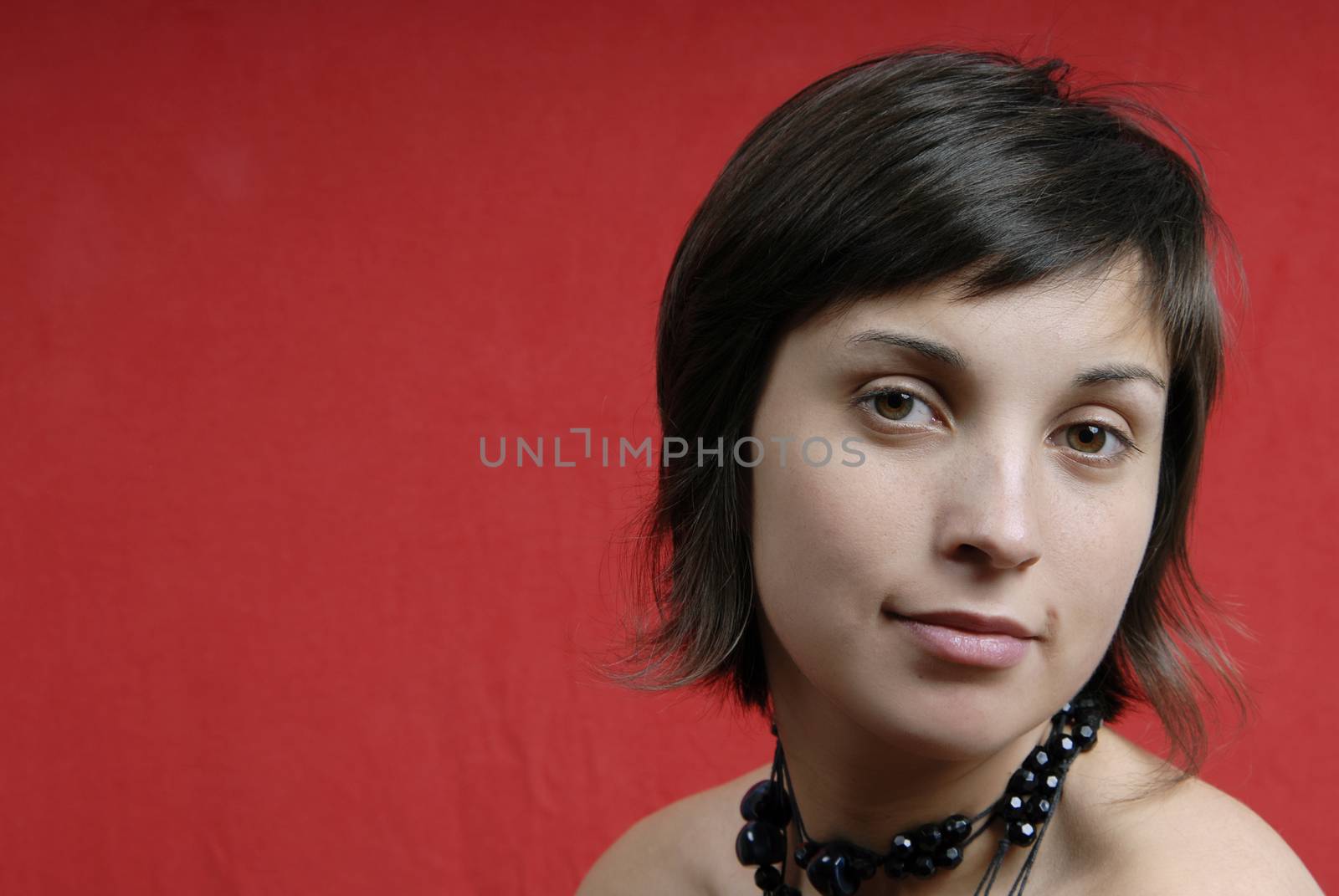 young woman portrait isolated on red background