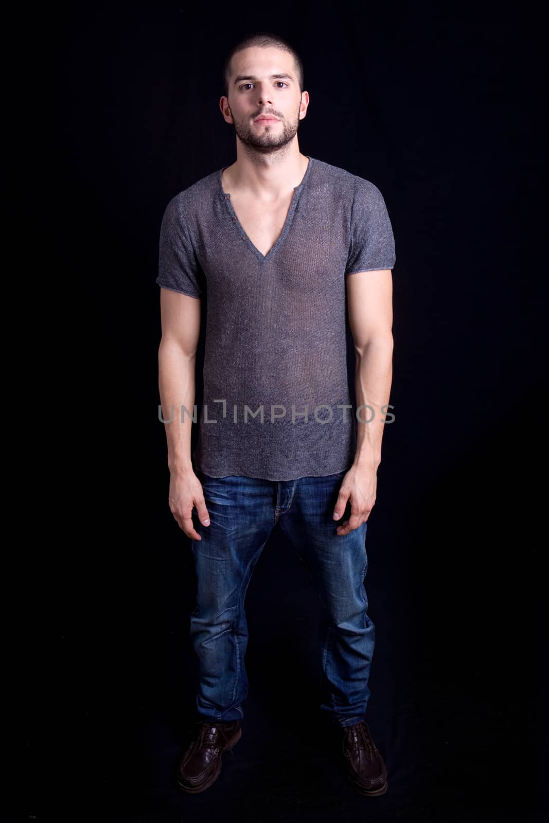 young casual man full body on a black background