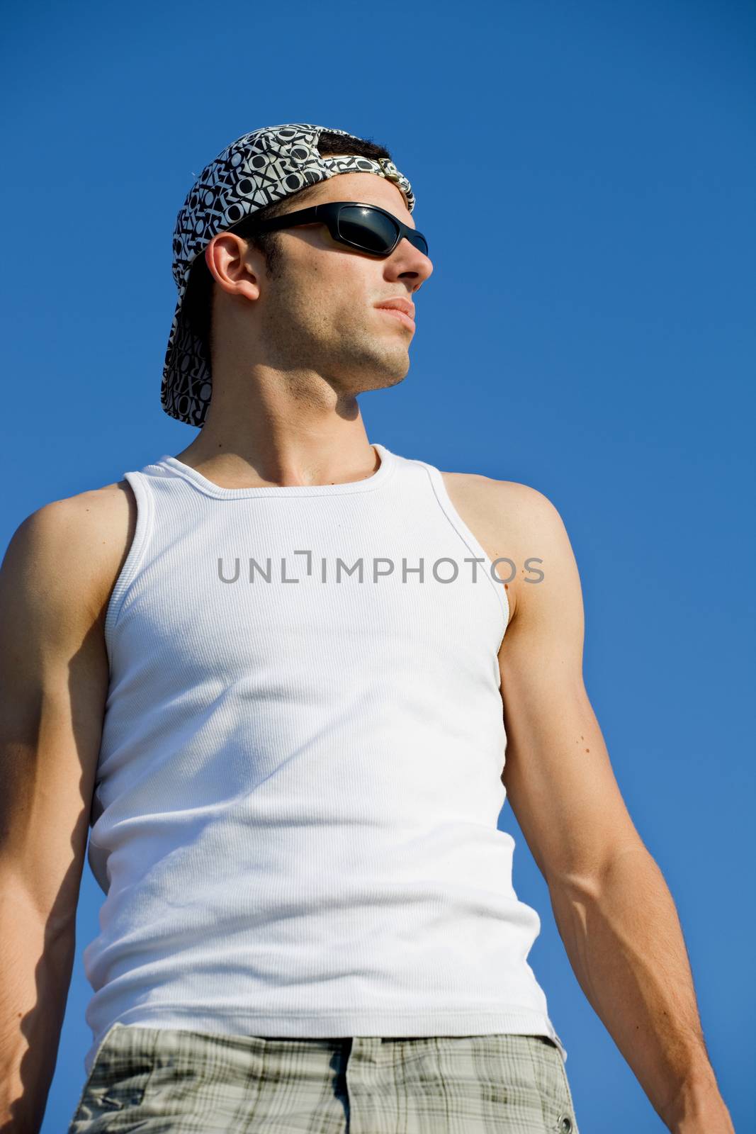 young casual man looking with the sky as background