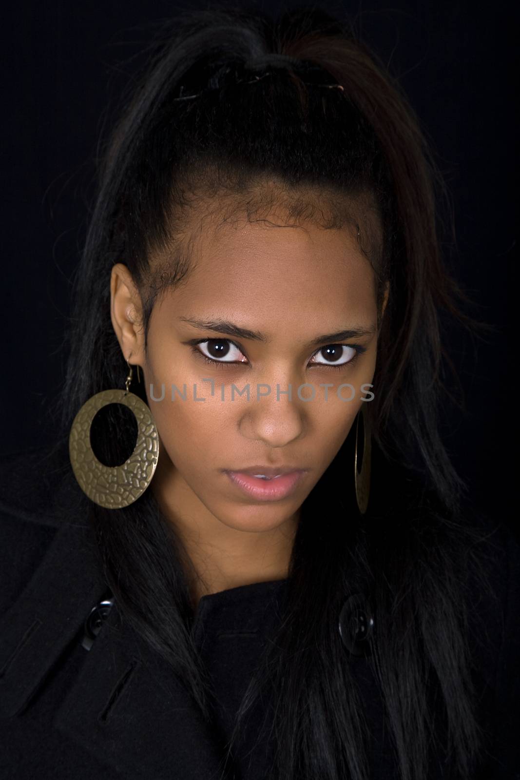 young beautiful woman close up portrait, on black background