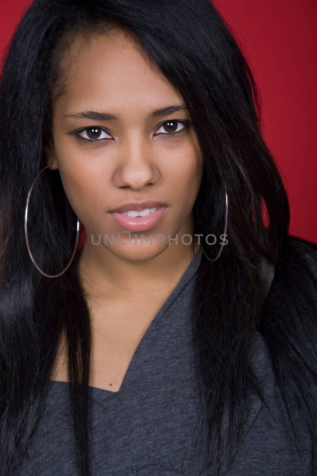 young beautiful woman closeup portrait, on a red background