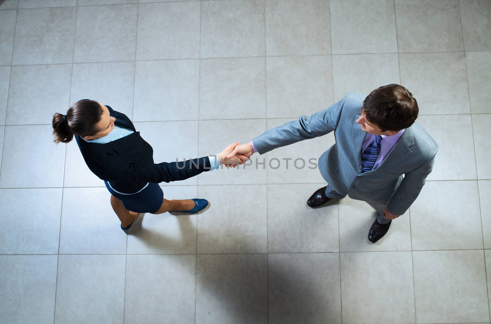 Business woman and businessman shaking hands, reach agreement