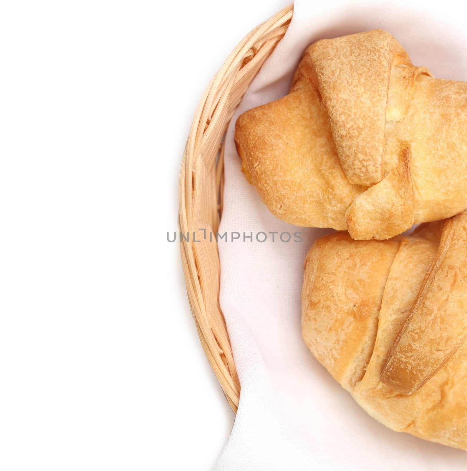 Croissants or crescent rolls in basket. Whole background.