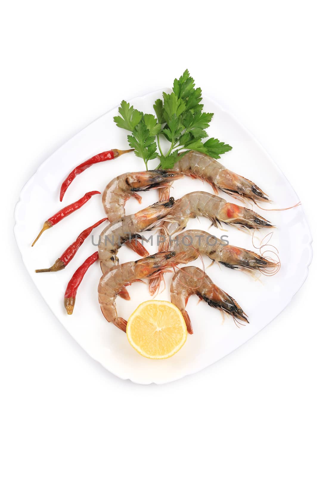 Fresh shrimps on plate with pepper. Isolated on a white background.