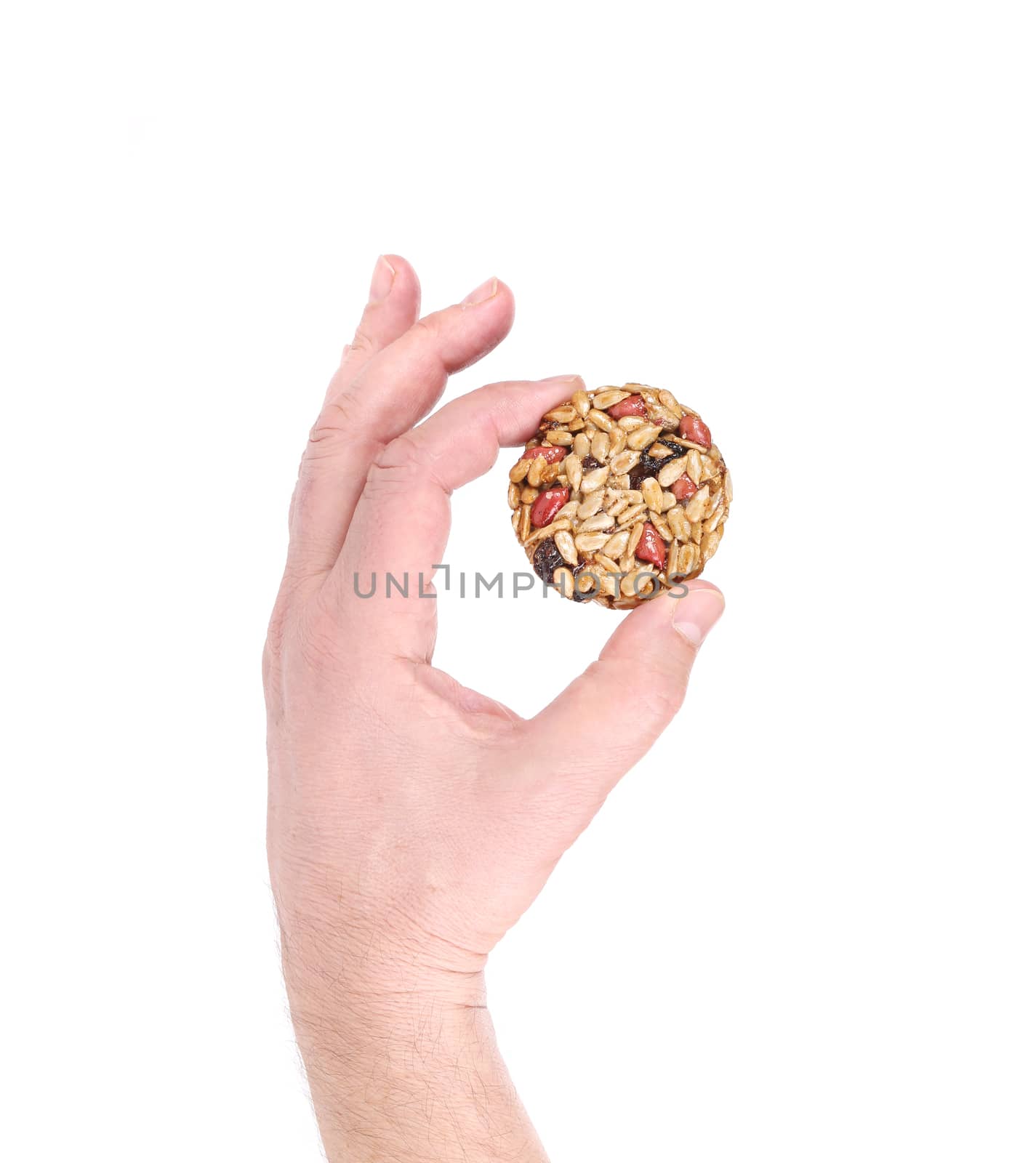 Hand holds candied peanuts sunflower seeds. Isolated on a white background.