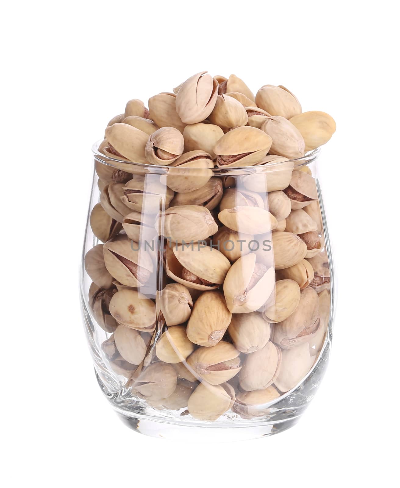 Glass full with pistachios. Isolated on a white background.