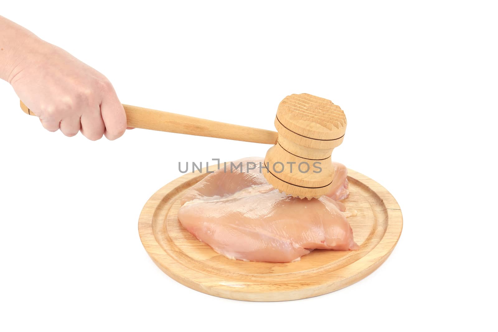 Raw chicken breast and mallet on wooden board. Isolated on a white background.