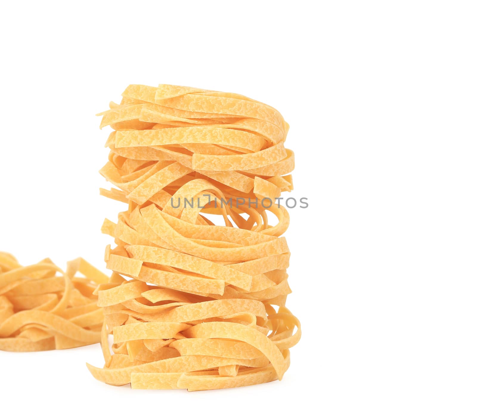 Tagliatelle paglia italian pasta. Isolated on a white background.