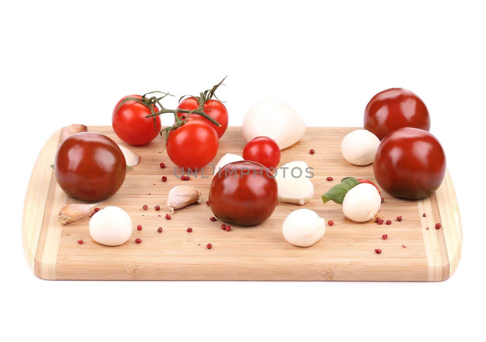 Tomatoes and mozzarella balls. Isolated on a white background.