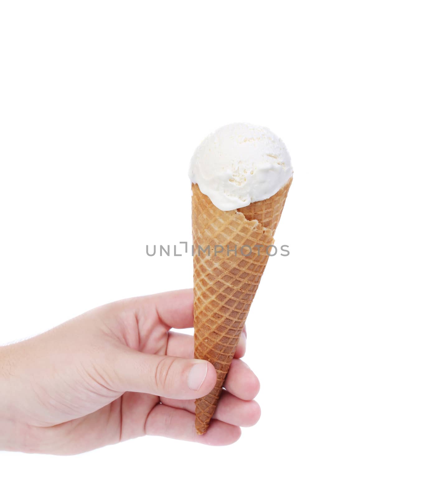 Hand holds cone vanille ice cream. Isolated on a white background.