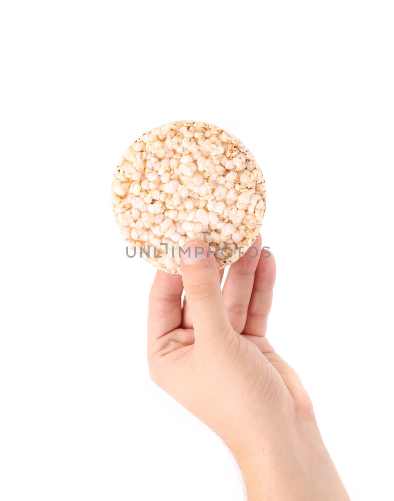 Hand holds rice cake. Isolated on a white background.