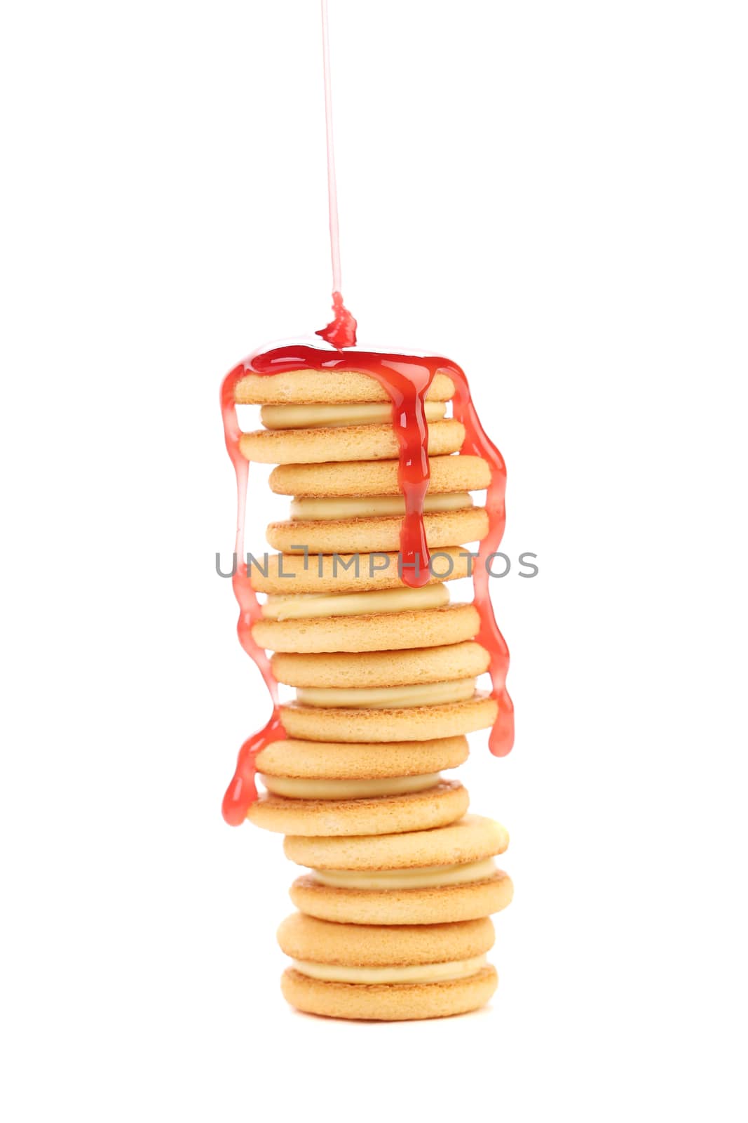 Stack of cookie biscuits with filling in strawberry sauce. On a white background