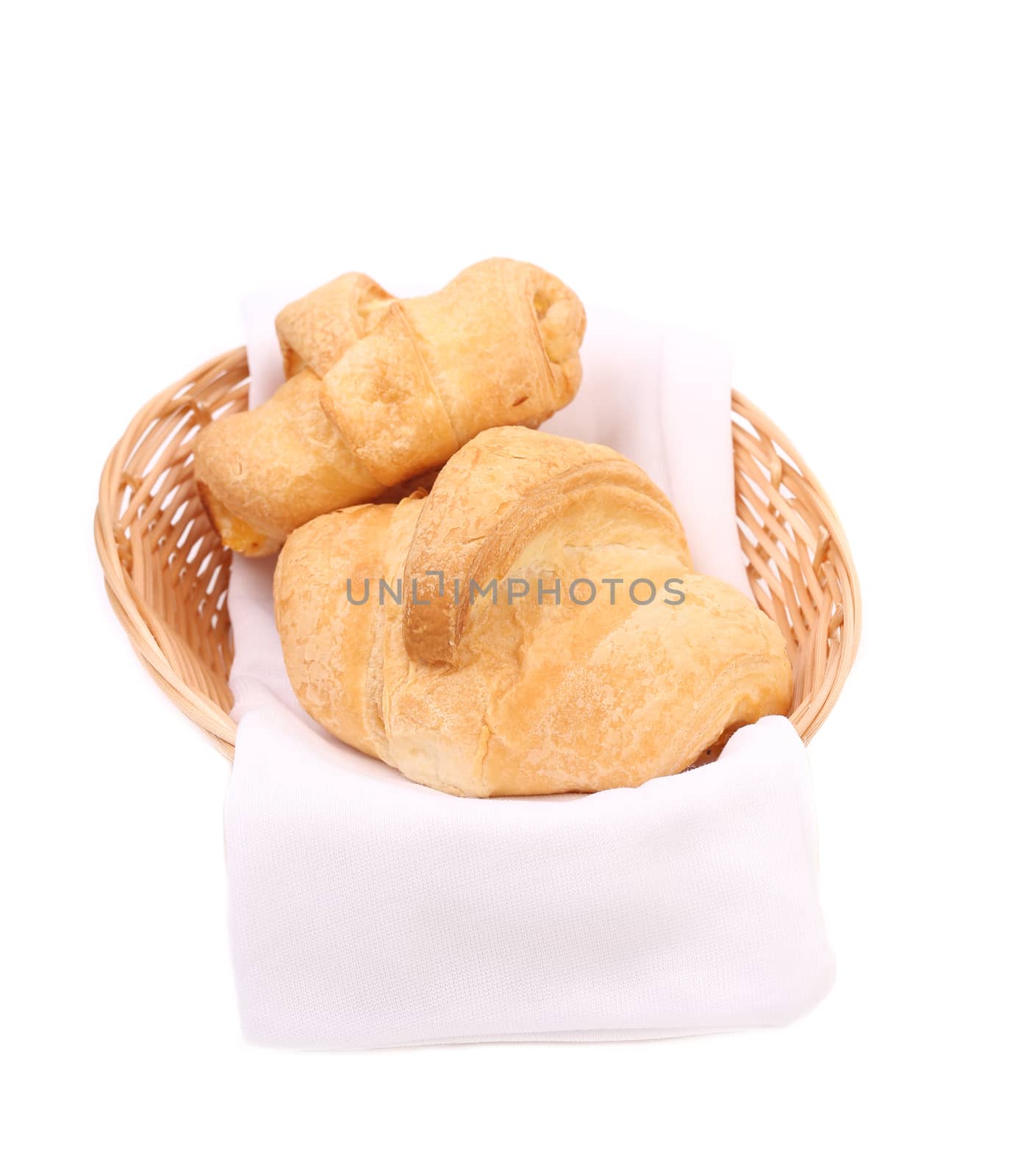 Croissants or crescent rolls in basket. Isolated on a white background.