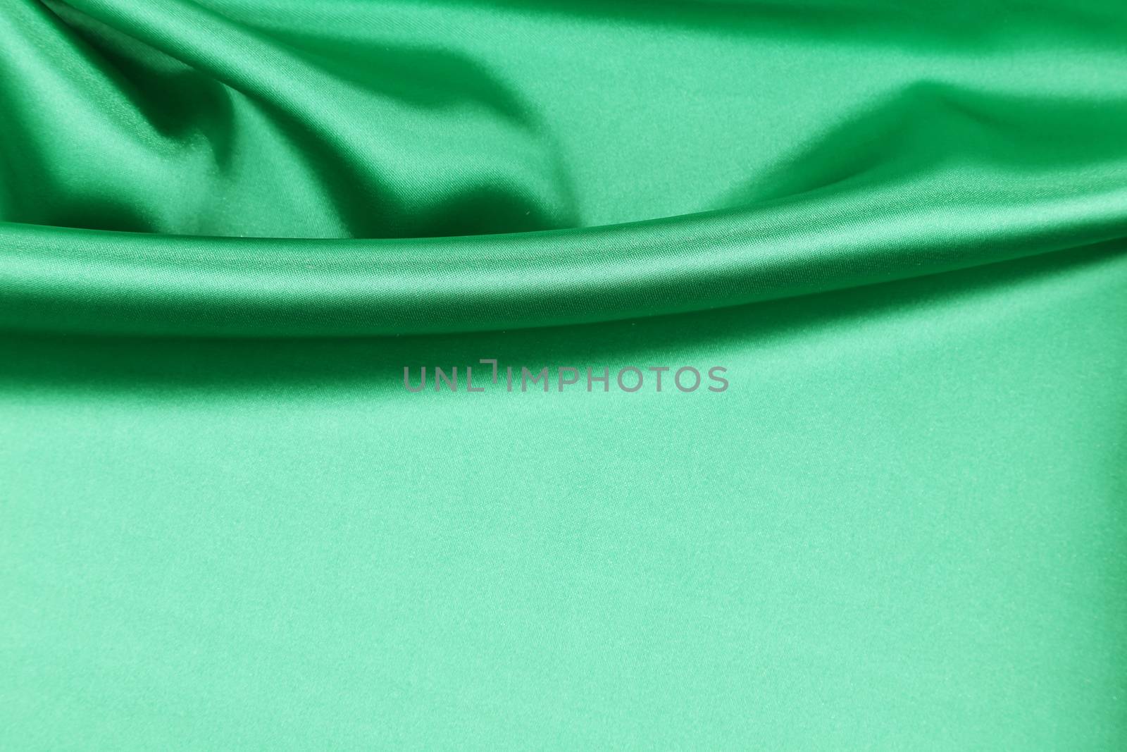 Green silk drapery. Close up. Whole background.