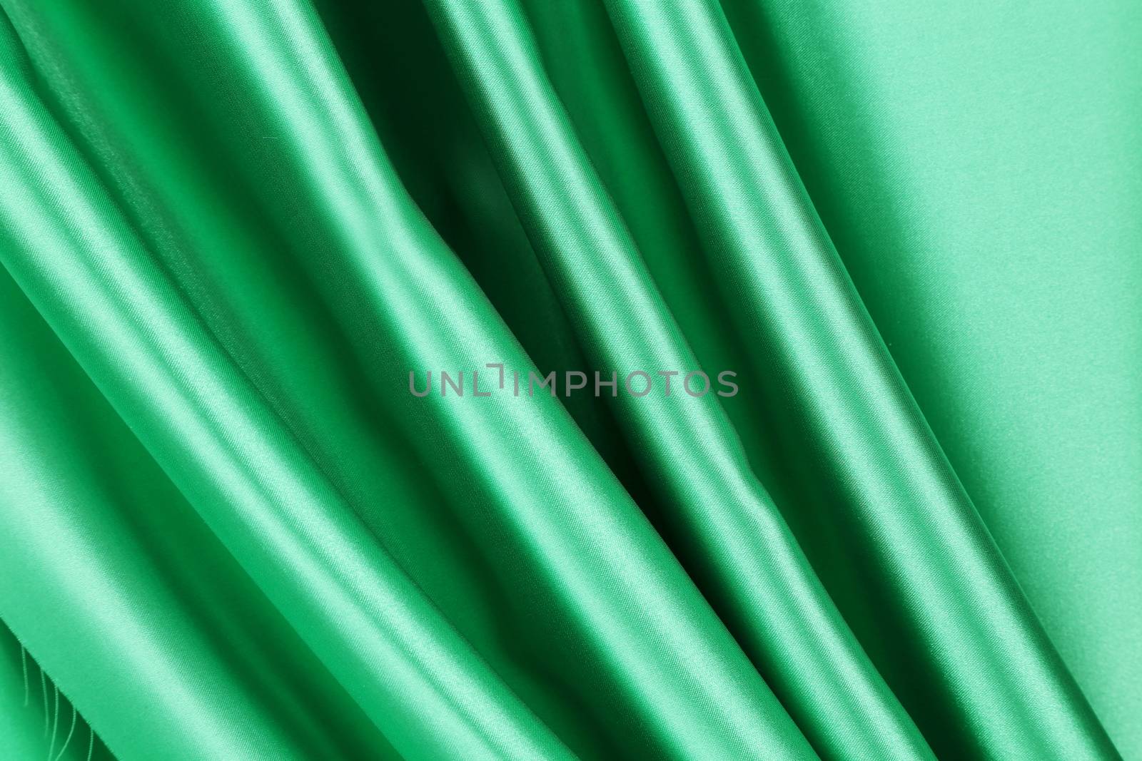 Green silk drapery. Close up. Whole background.