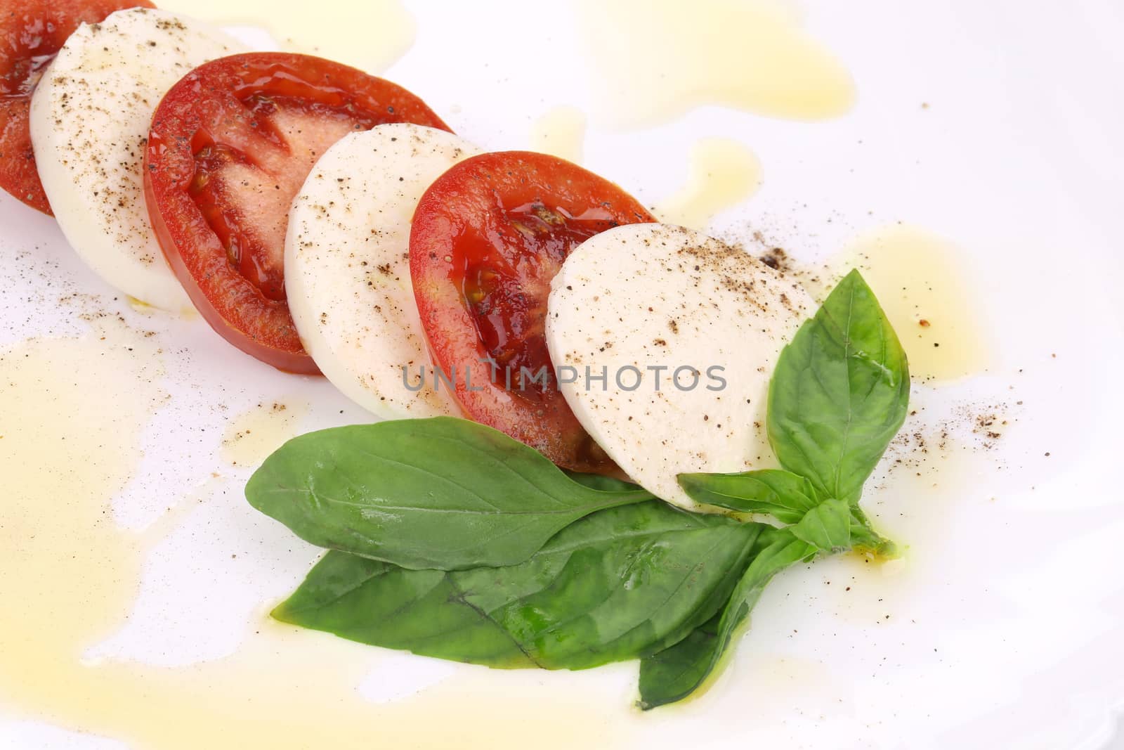 Tasty caprese salad. Isolated on a white background.