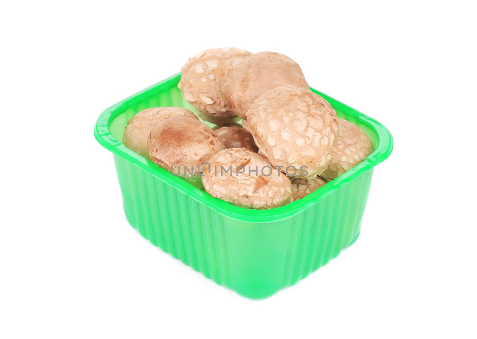 Plastic box with champignons. Isolated on a white background.