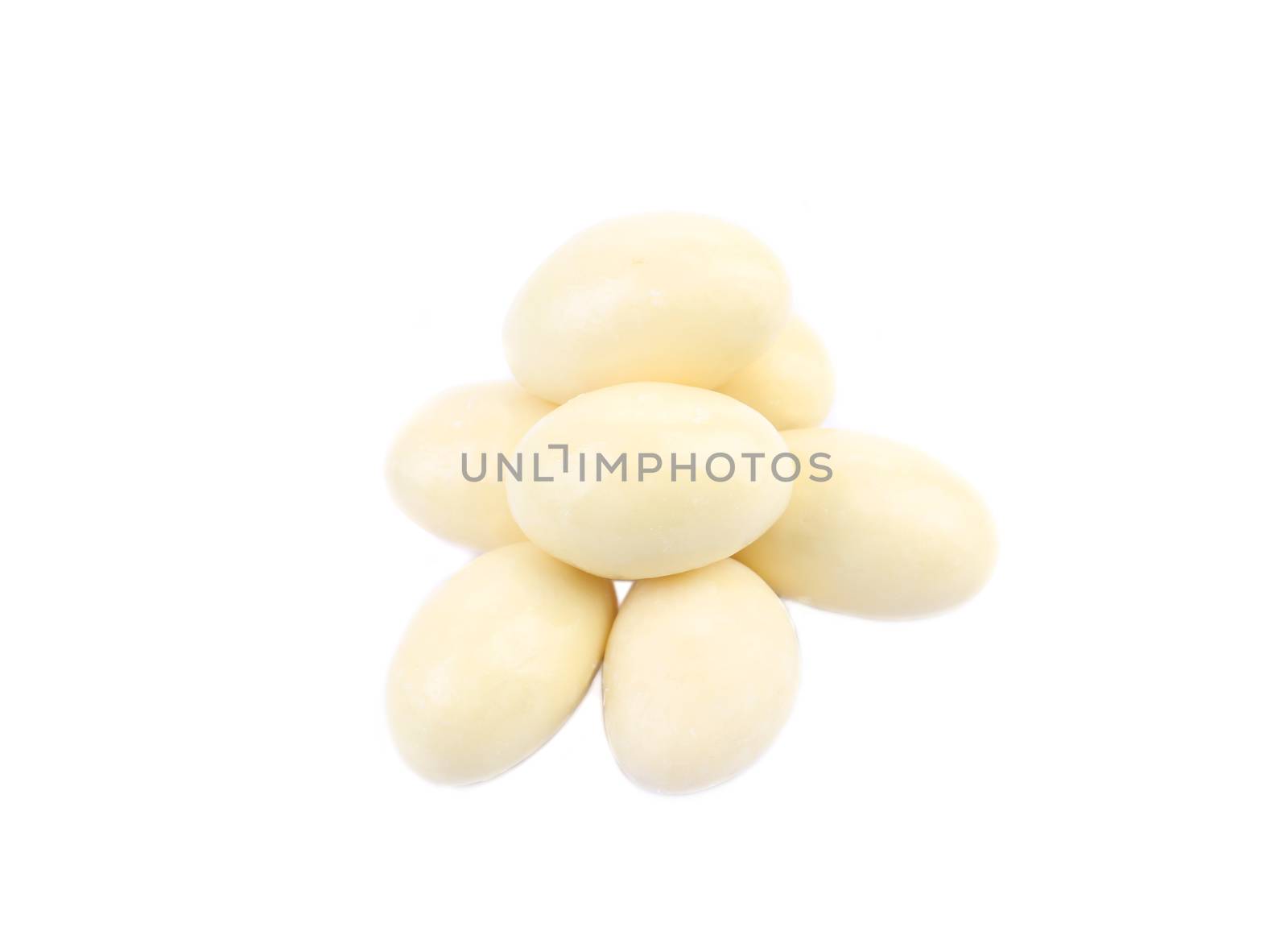 Pill of white chocolate dragee. Isolated on a white background.