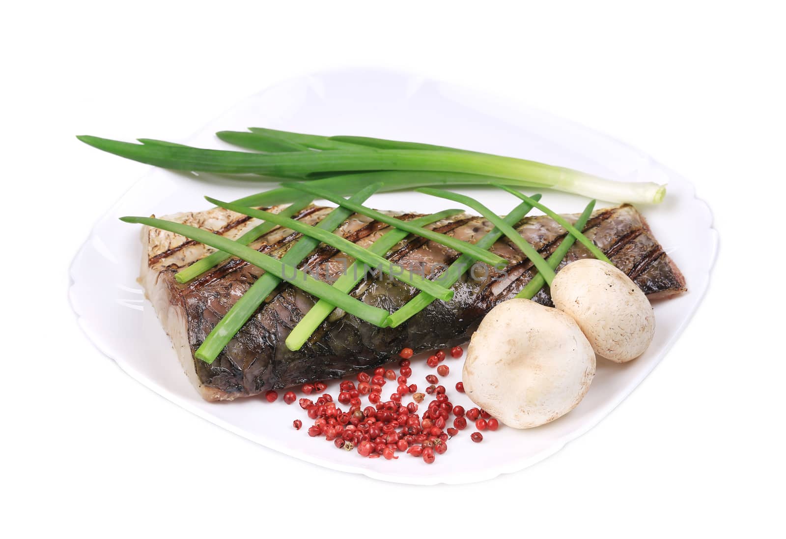 Grilled fish with green onions. Isolated on a white background.