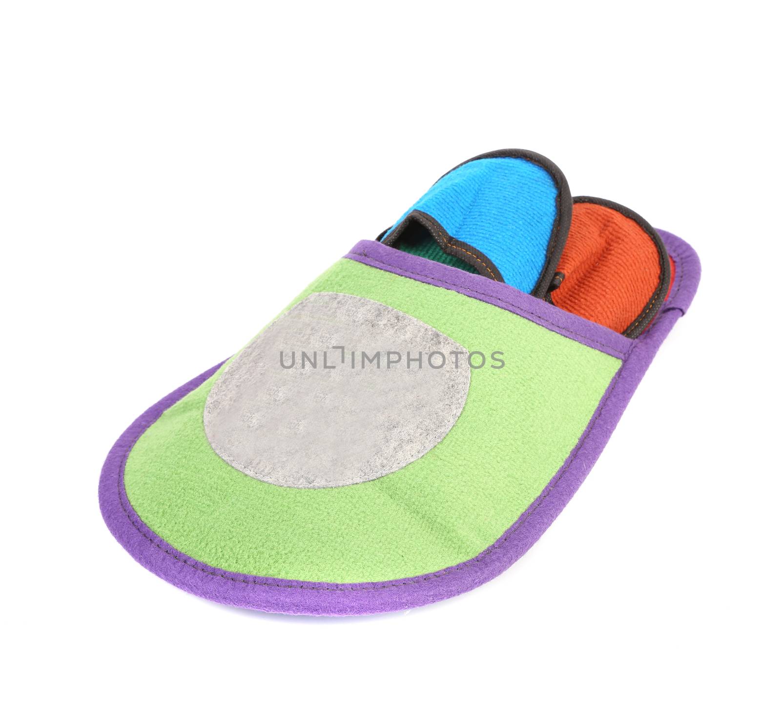 Colourful slippers into big slipper. Isolated on a white background.