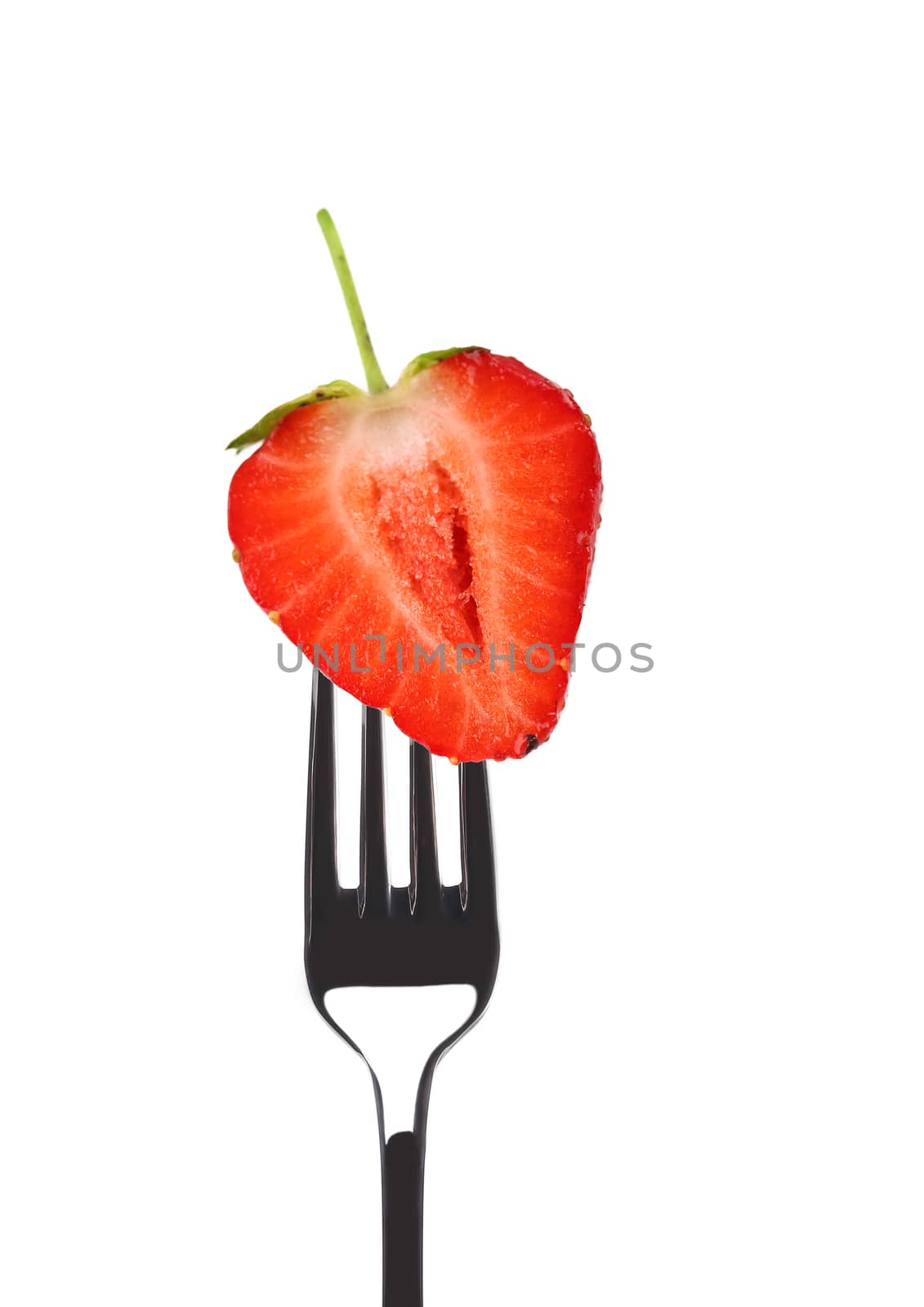 Fresh big strawberry on a fork. Isolated on a white background.