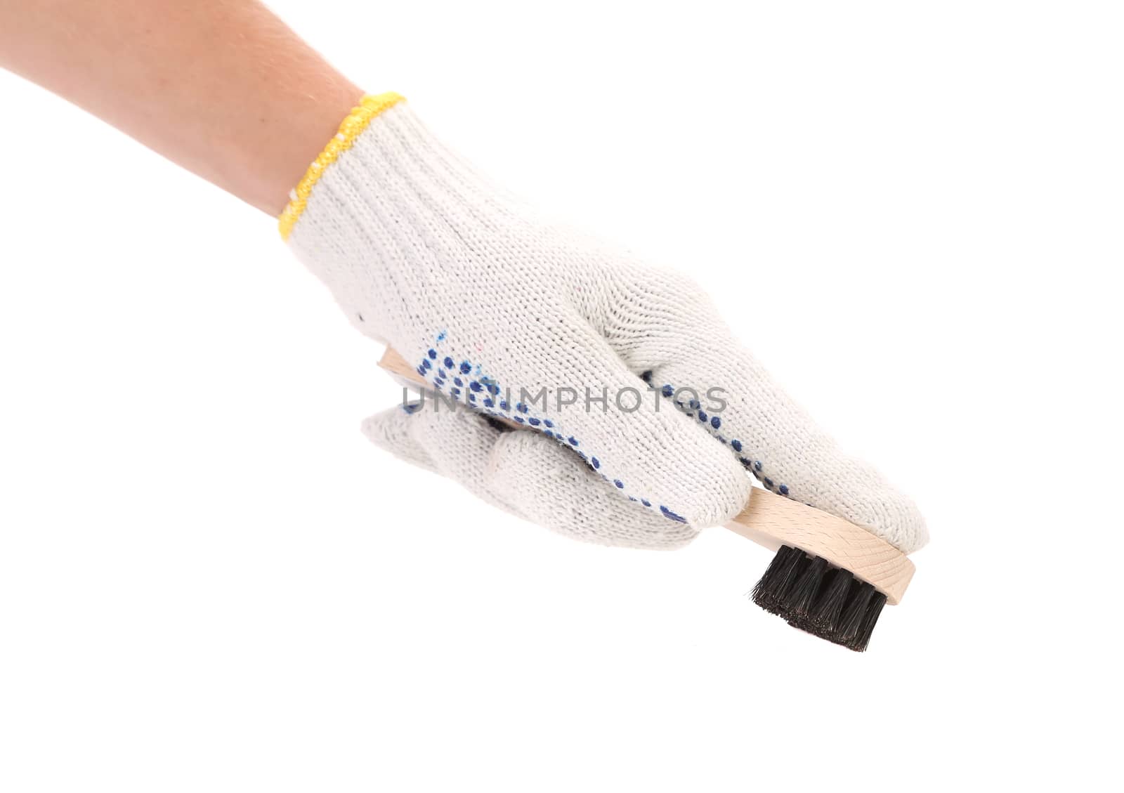 Hand holds shoes brush. Isolated on a white background.