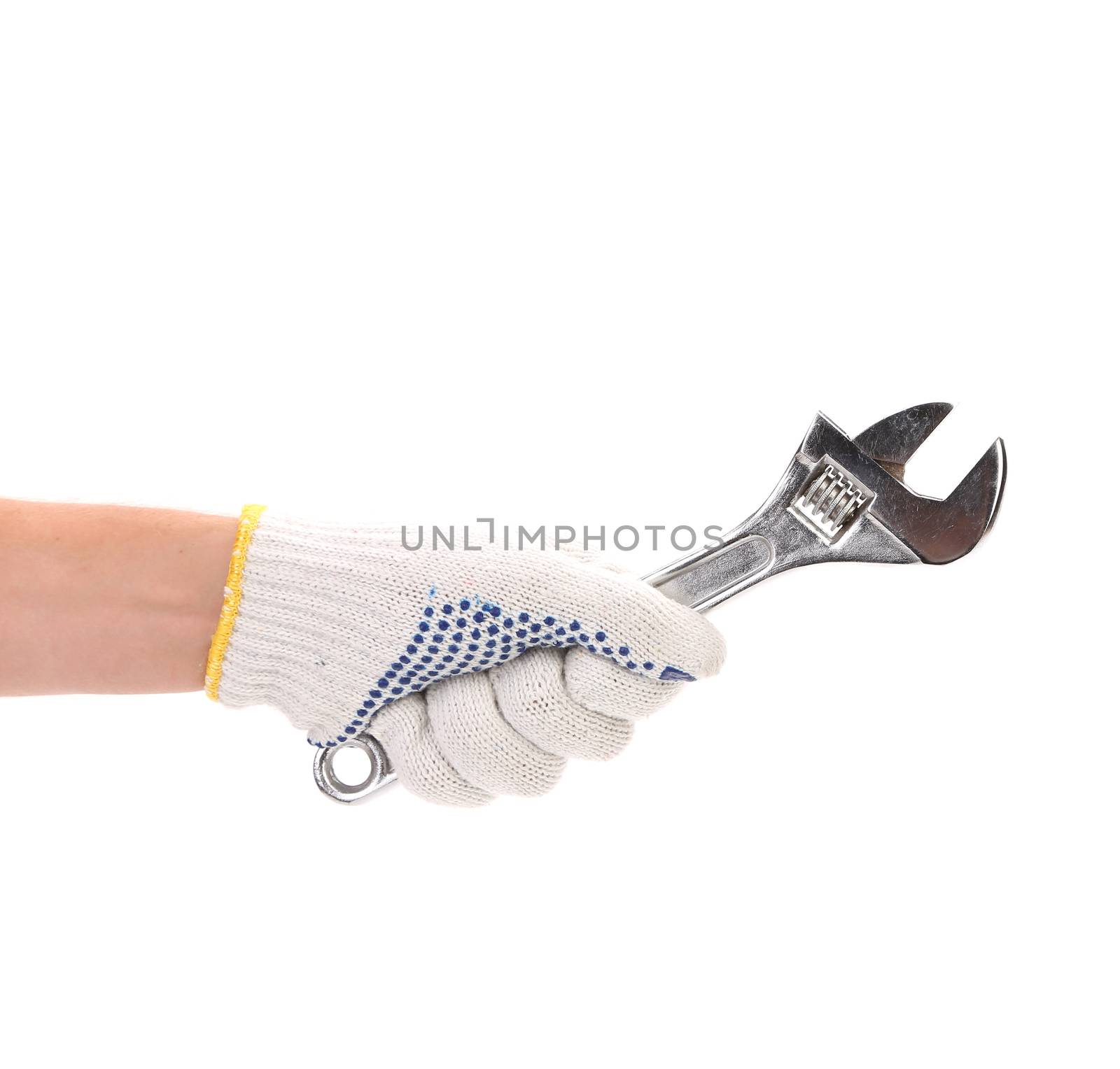 Hand in gloves holding adjustable wrench. Isolated on a white background.