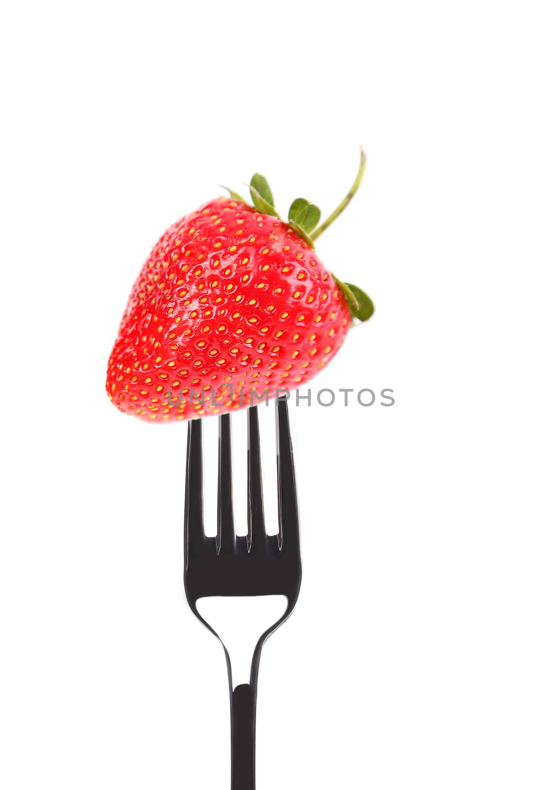 Strawberry on a fork. Isolated on a white background.