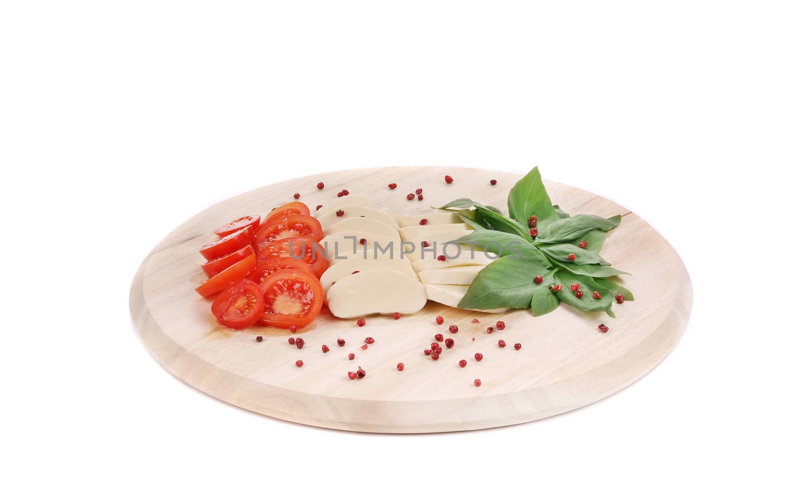 Caprese salad with pepper on platter. Isolated on a white background.