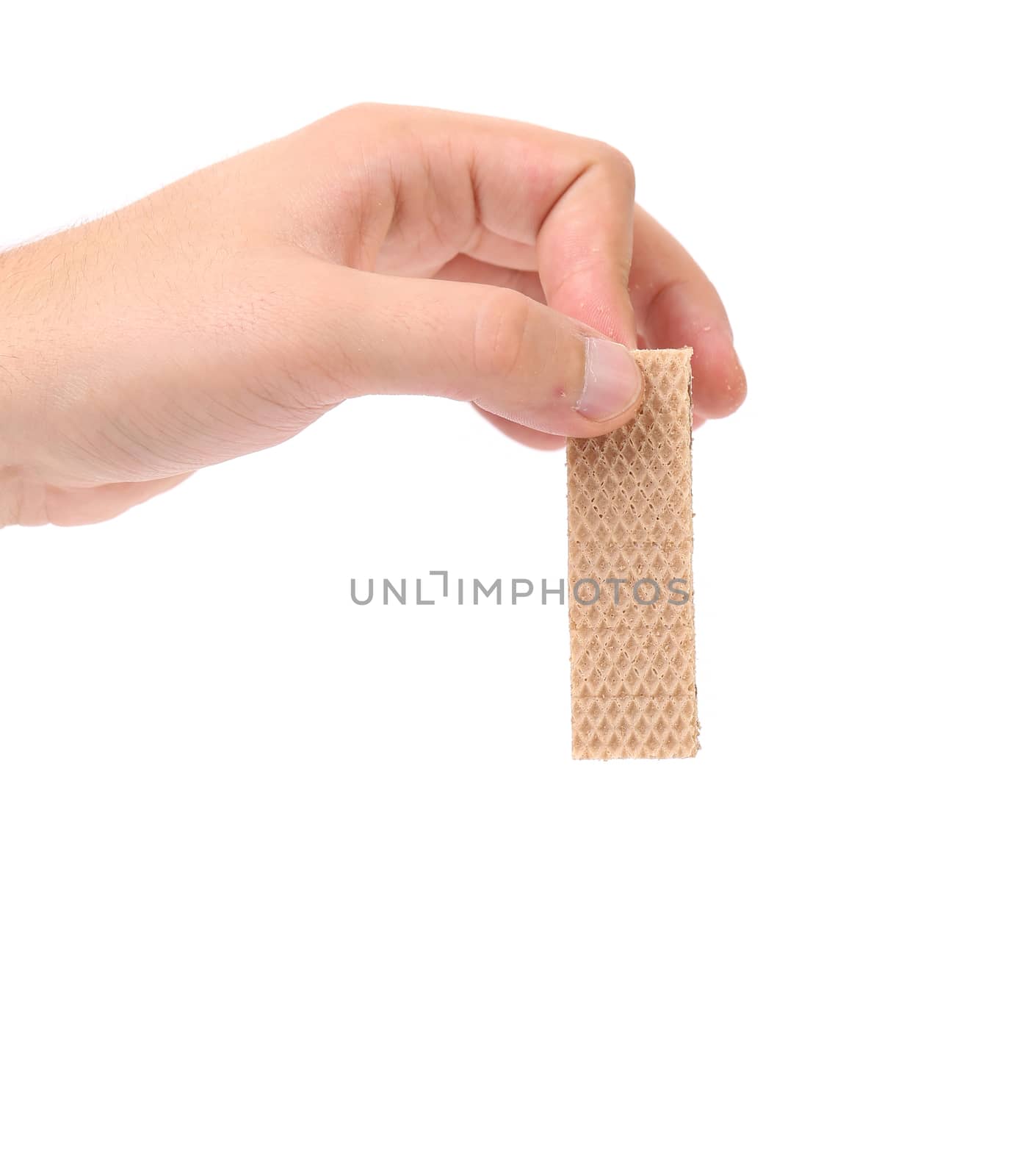 Hand holds tasty waffle. Isolated on a white background.