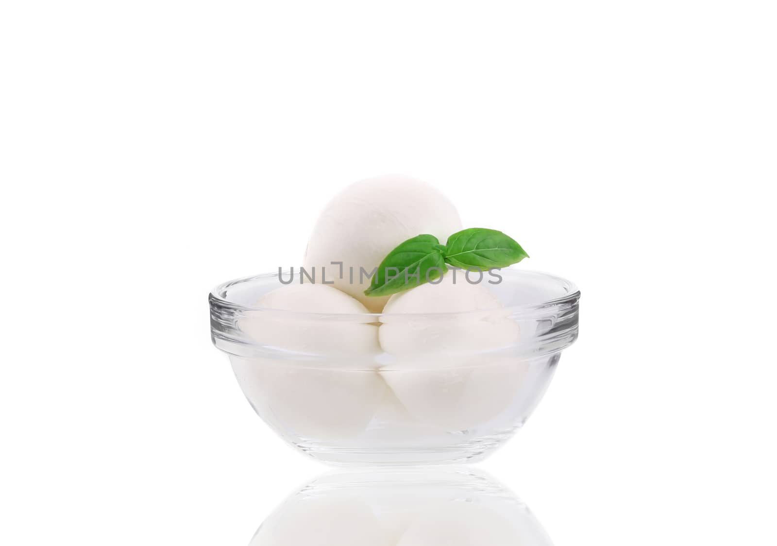 Mozzarella balls in glass bowl. Isolated on a white background.