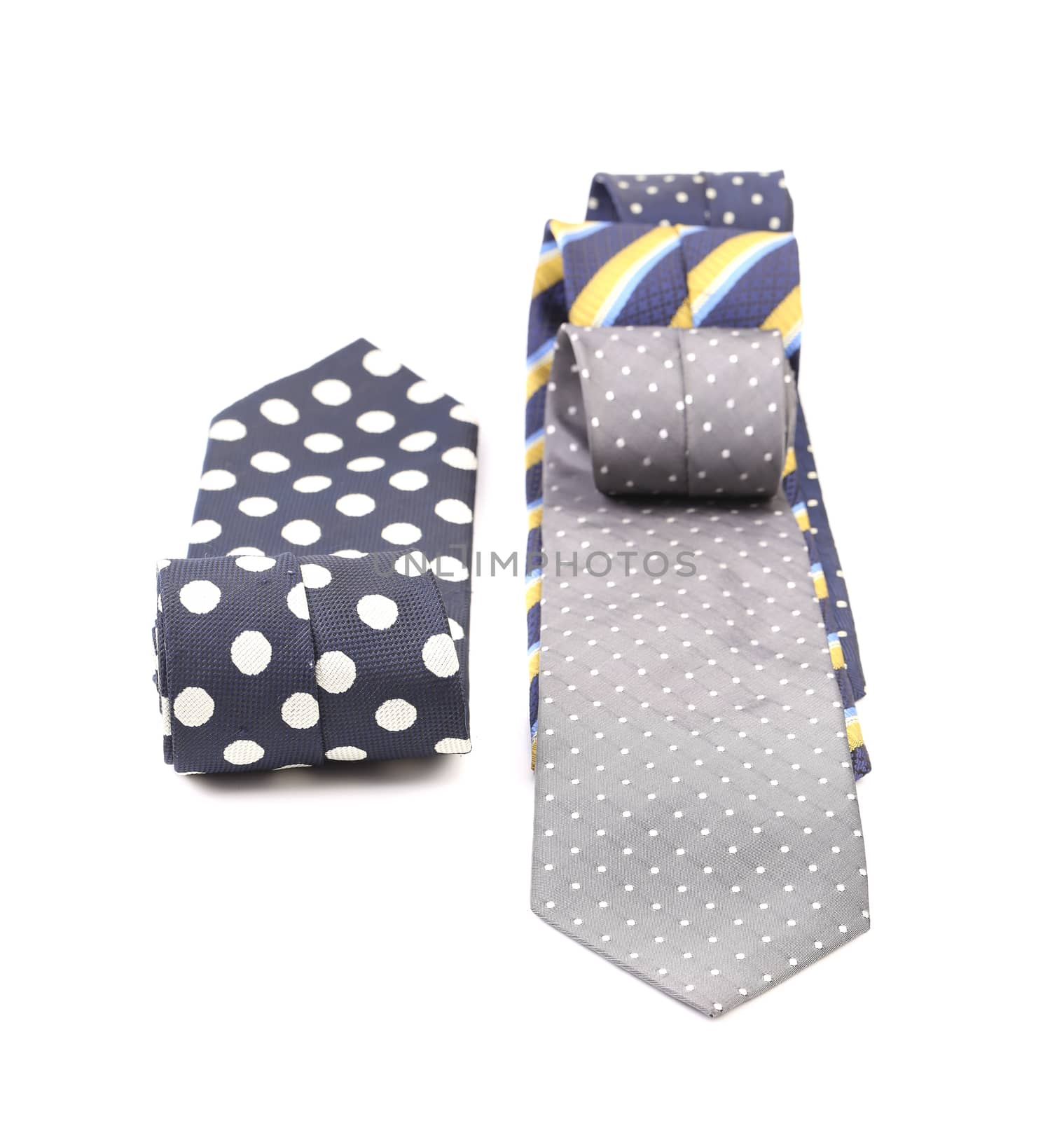 Three rolled multi-colored tie. Isolated on white background.