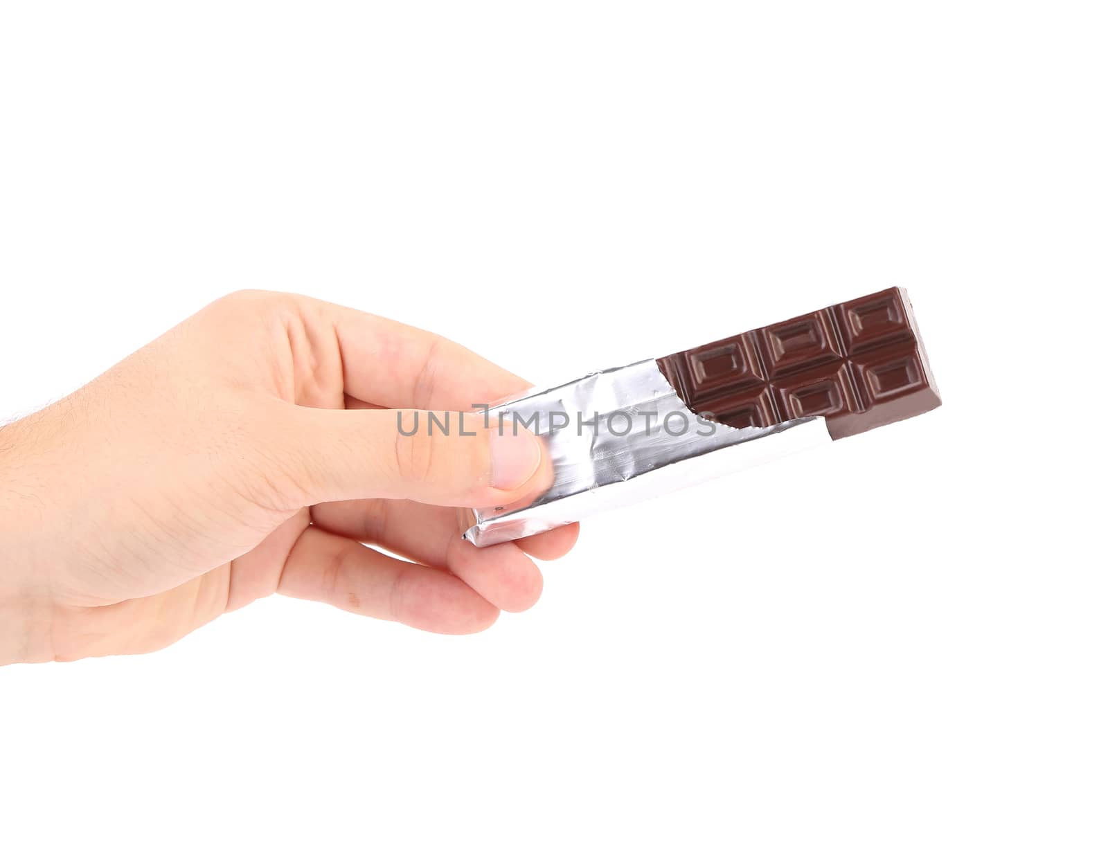 Hand holds chocolate bar in foil. Isolated on a white background.