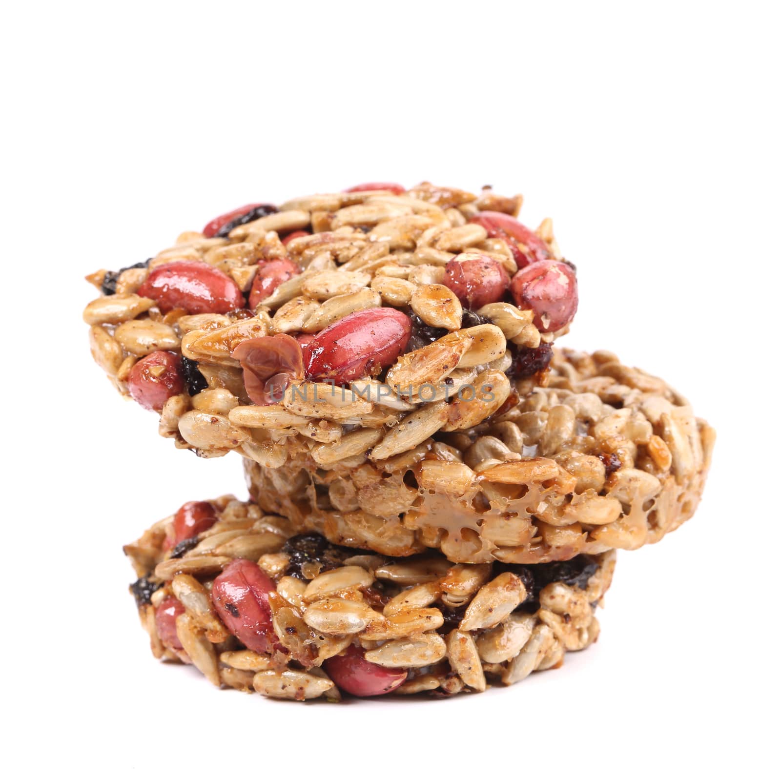Stack of candied peanuts sunflower seeds. Isolated on a white background.