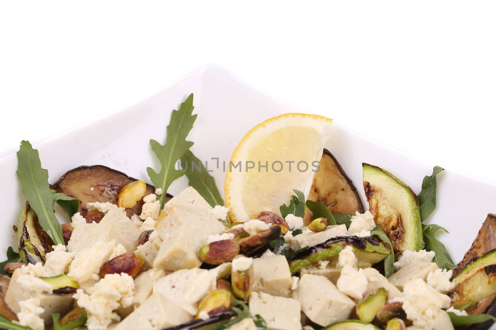 Salad with grilled vegetables and tofu. Whole background.
