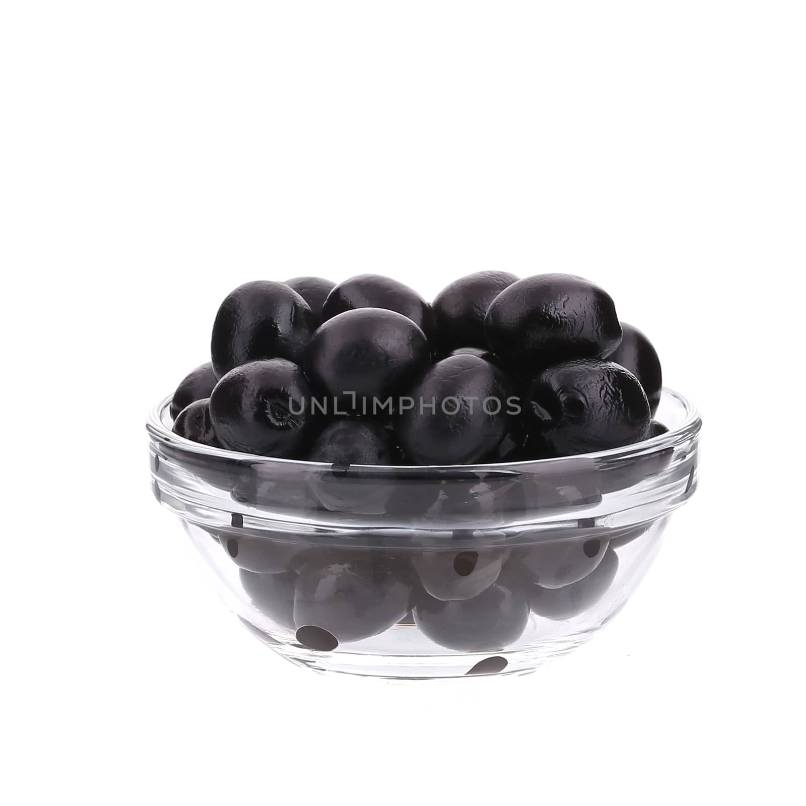 Glass bowl with black olives. by indigolotos