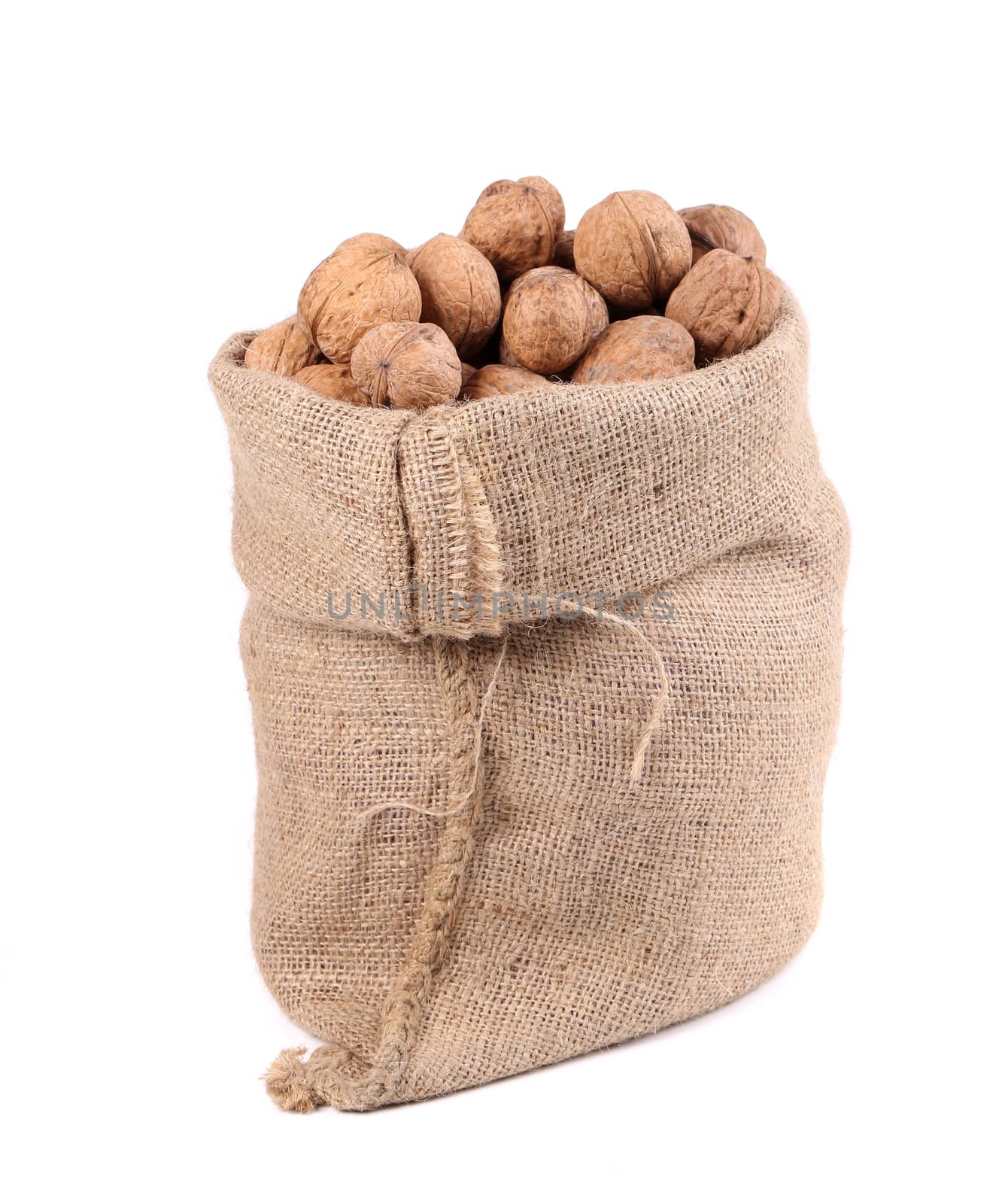 Walnuts in burlap bag. Isolated on a white background.