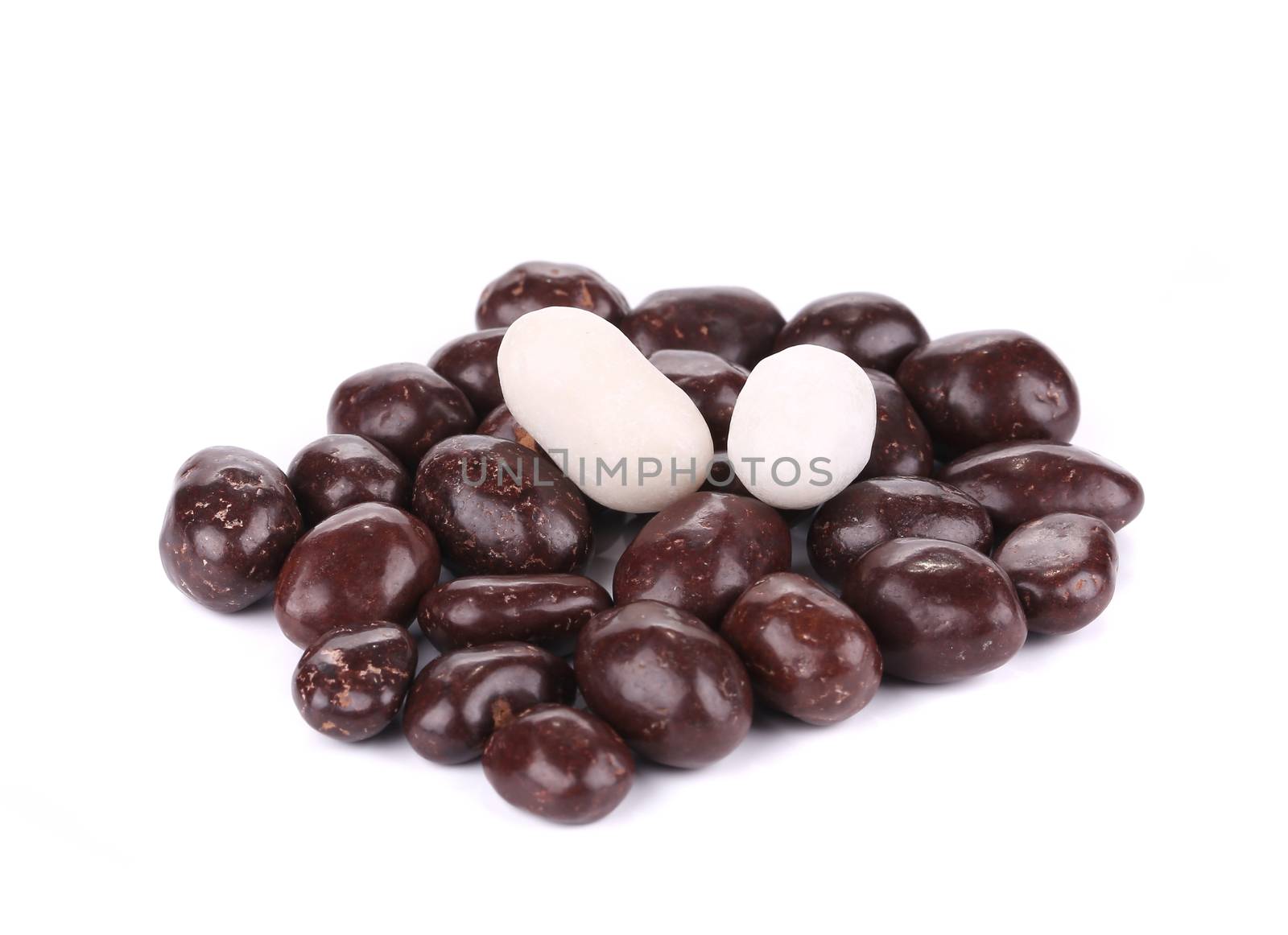 Dark brown dragee in chocolate cover. Isolated on a white background.