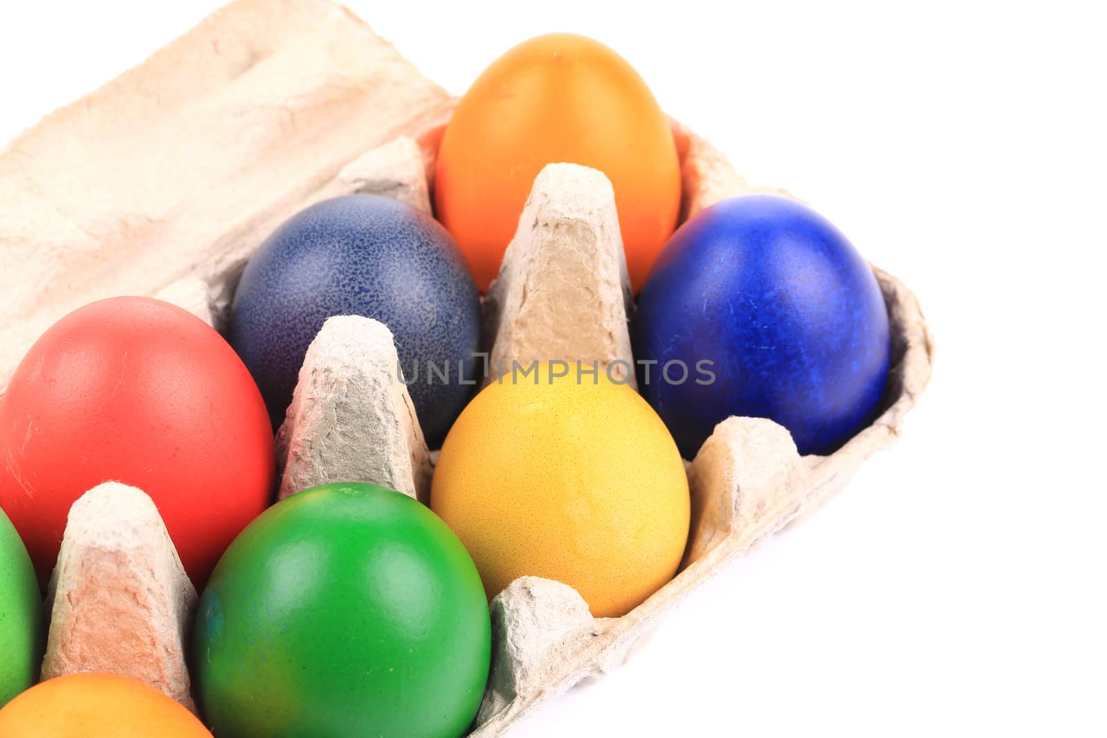 Cardboard box with Easter colored eggs. by indigolotos