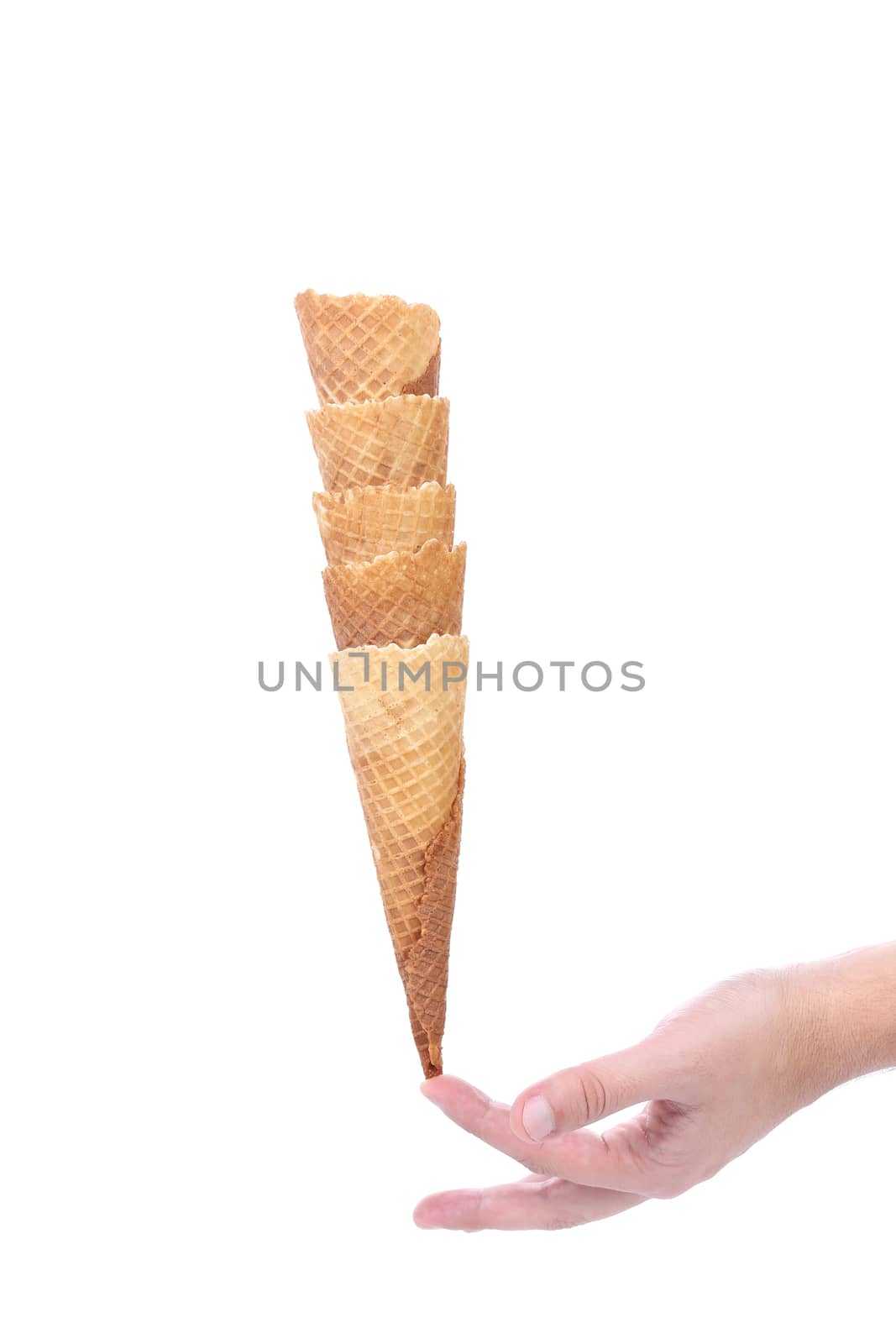 Hand hold stake of wafer cup for ice-cream. Isolated on a white background.