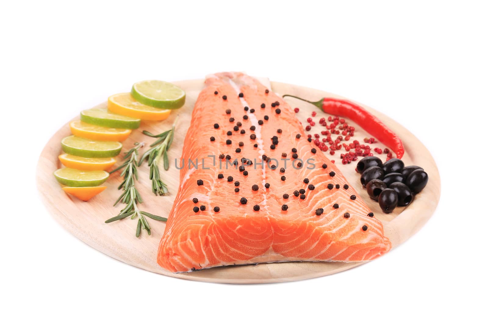 Salmon fillet with pepper and olives. Isolated on a white background.