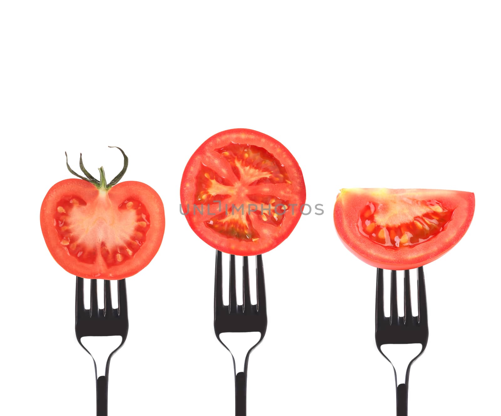 Tomato slices on forks. Isolated on a white background.