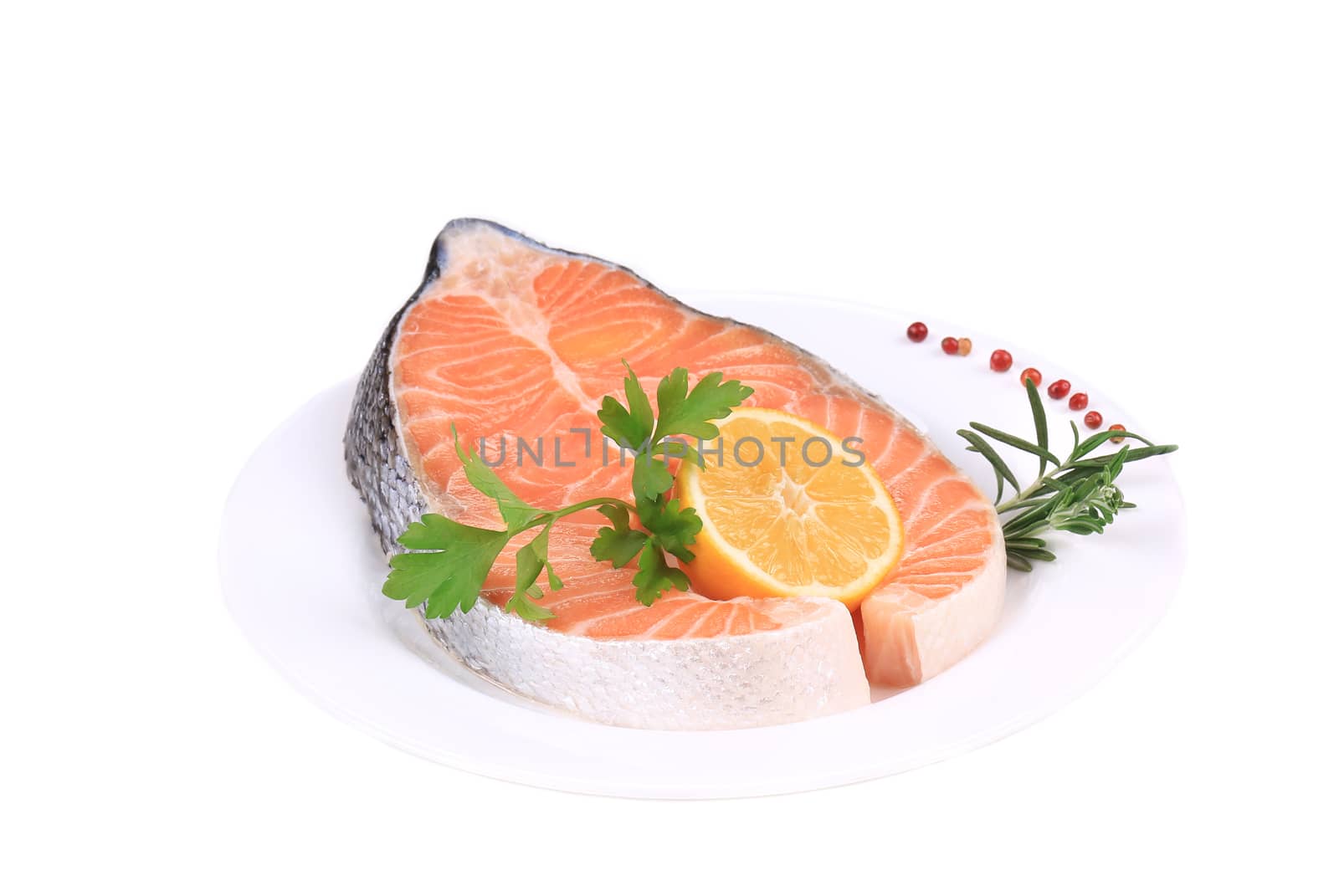 Fresh salmon steak with vegetables. Isolated on a white background.