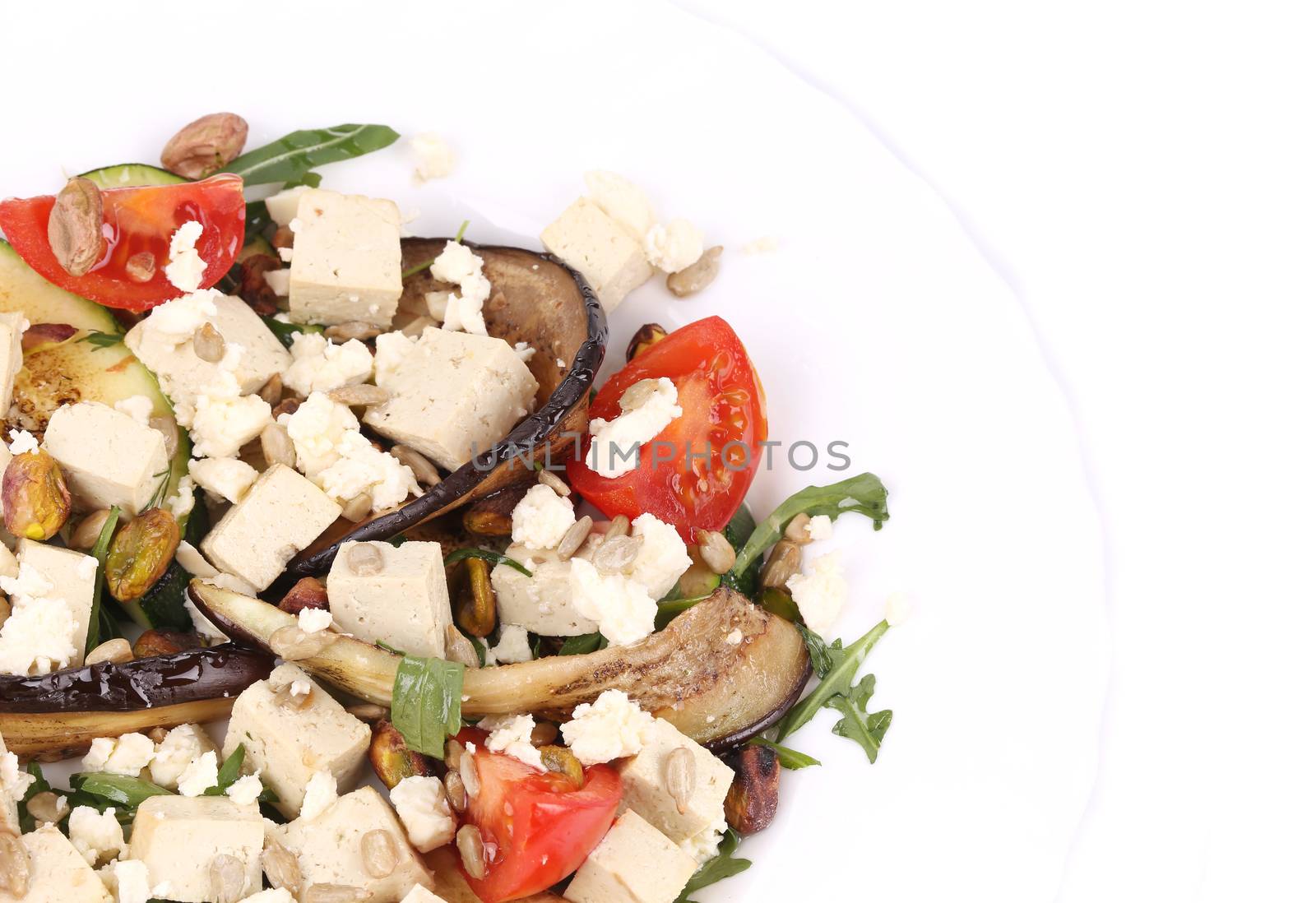 Salad with grilled vegetables and tofu. Whole background.