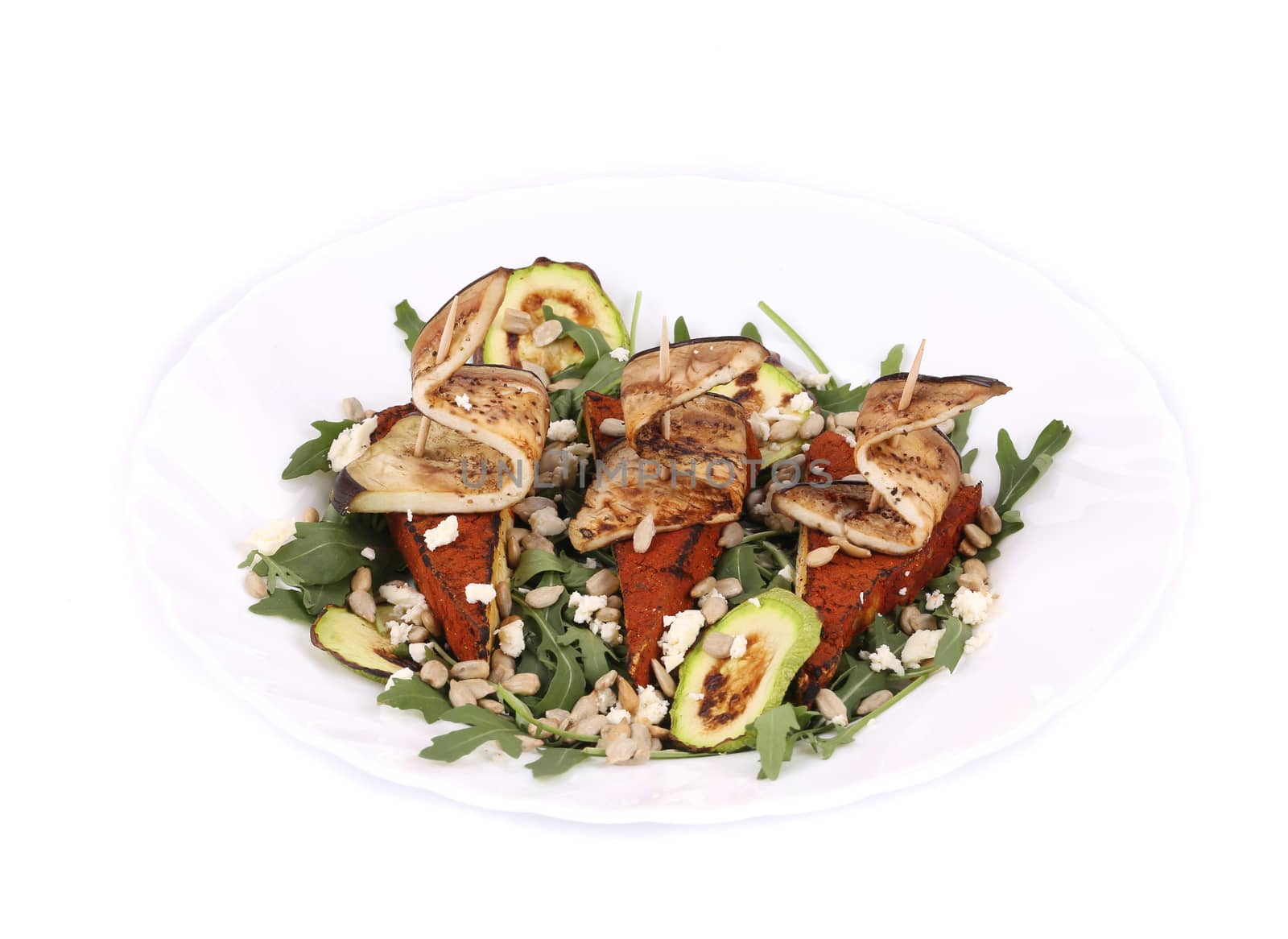 Salad with grilled vegetables and tofu. Isolated on a white background.