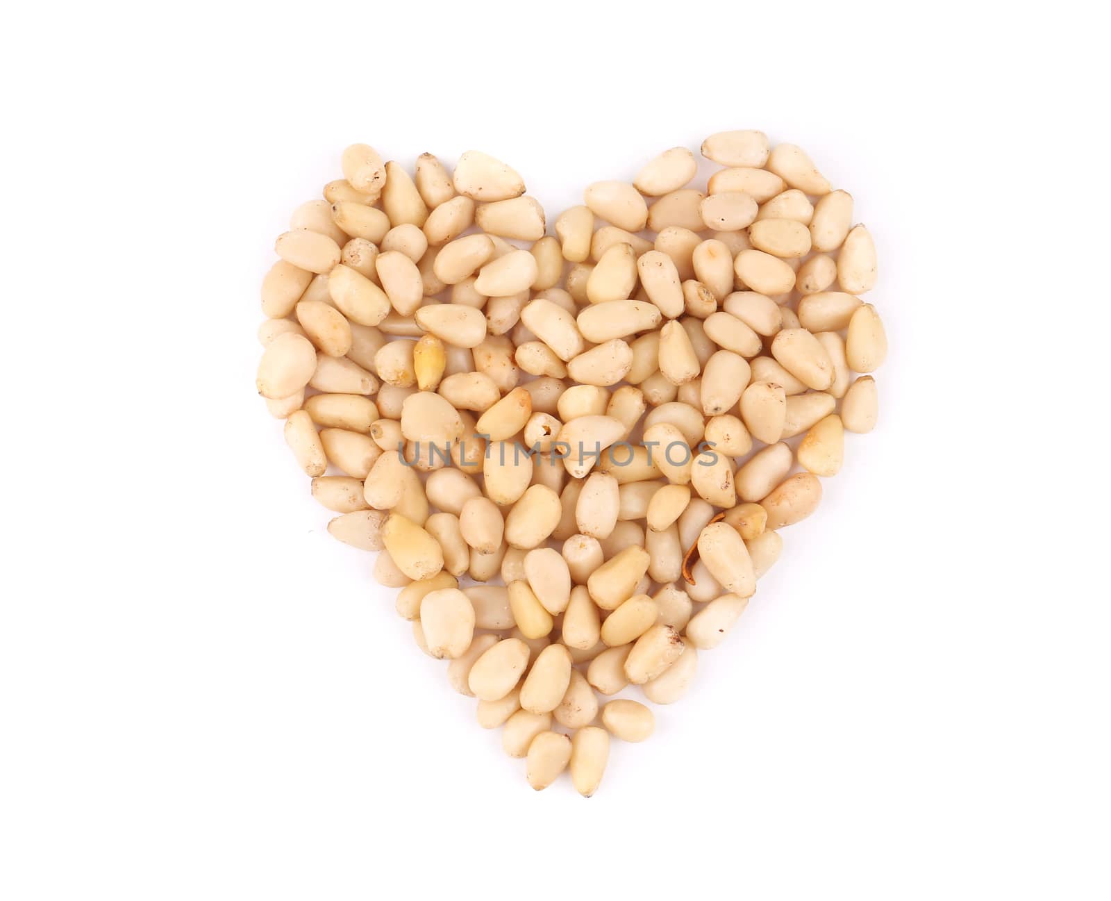 Heart shape from pine nuts. Isolated on a white background.