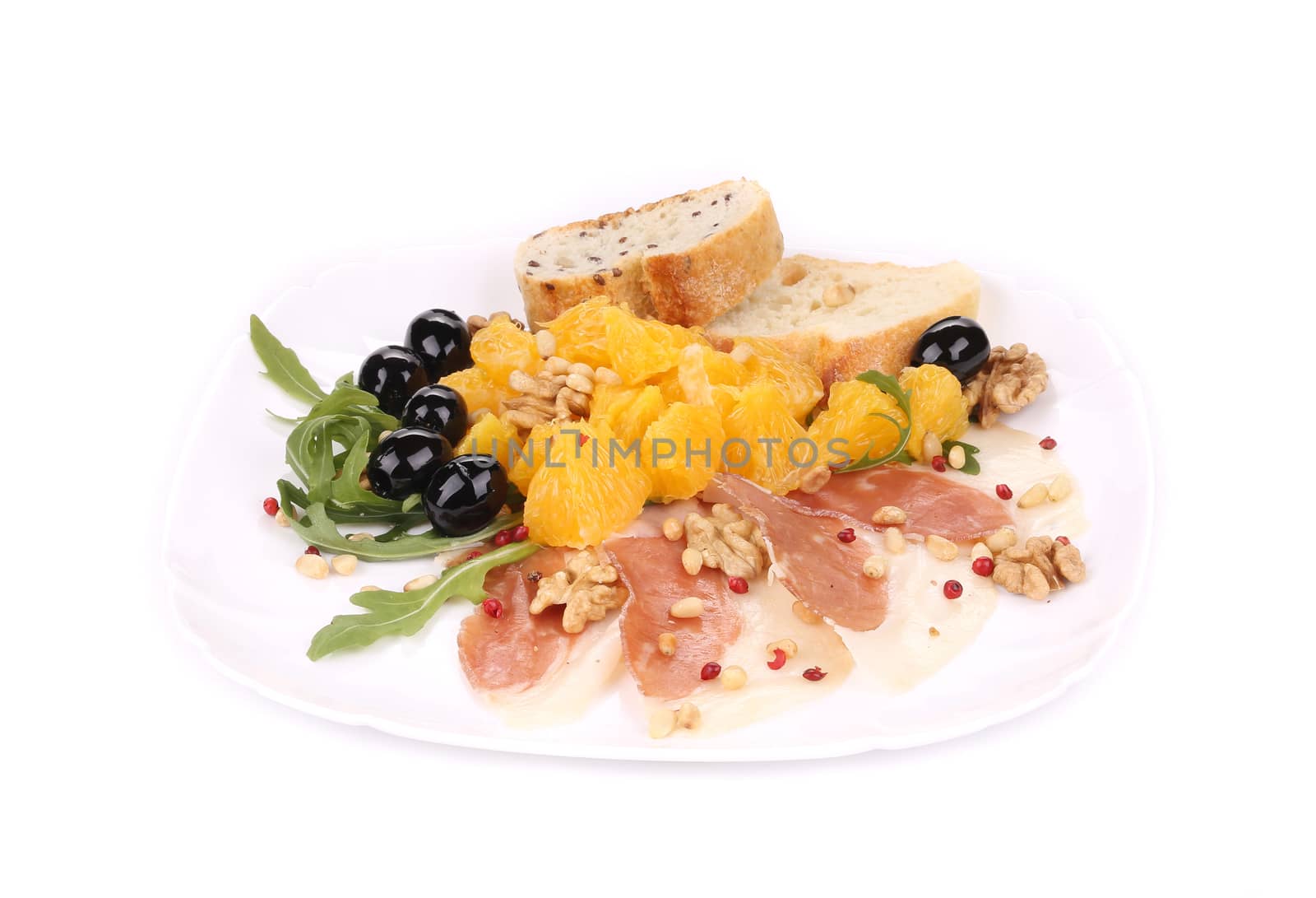 Salad with arugula and prosciutto. Isolated on a white background.