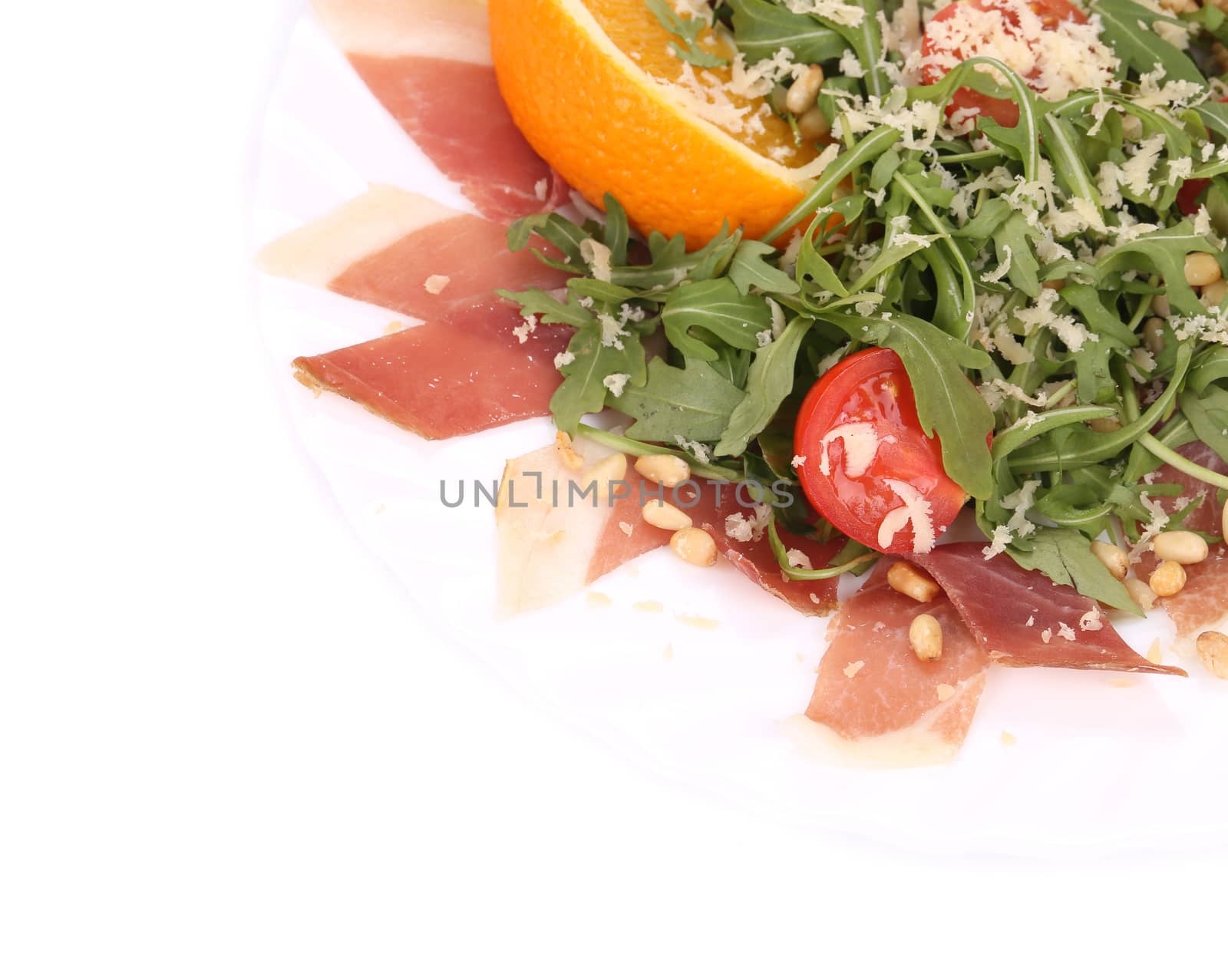 Salad with arugula and prosciutto. Whole background.